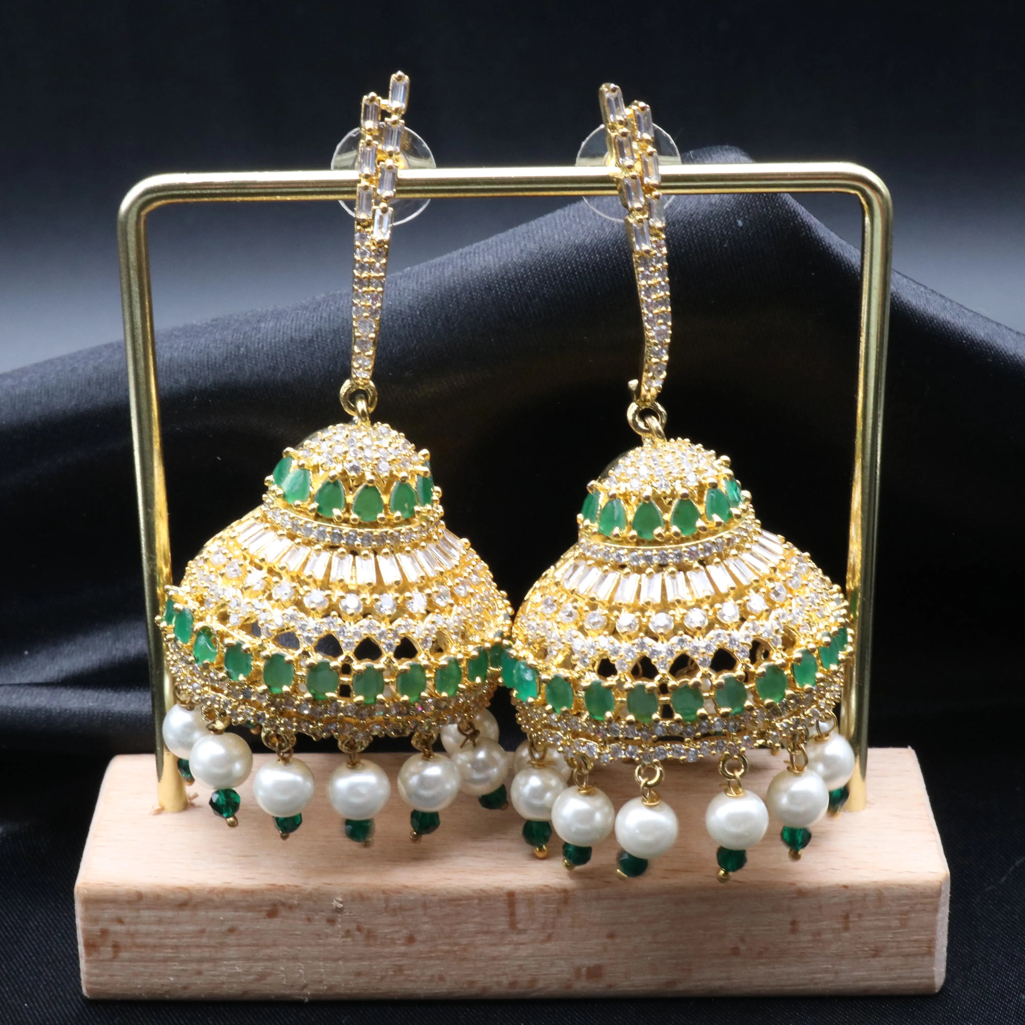 Pakistani design jhumkay with jarao craftsmanship. Green and clear gemstones with pearl accents providing an exquisite touch.