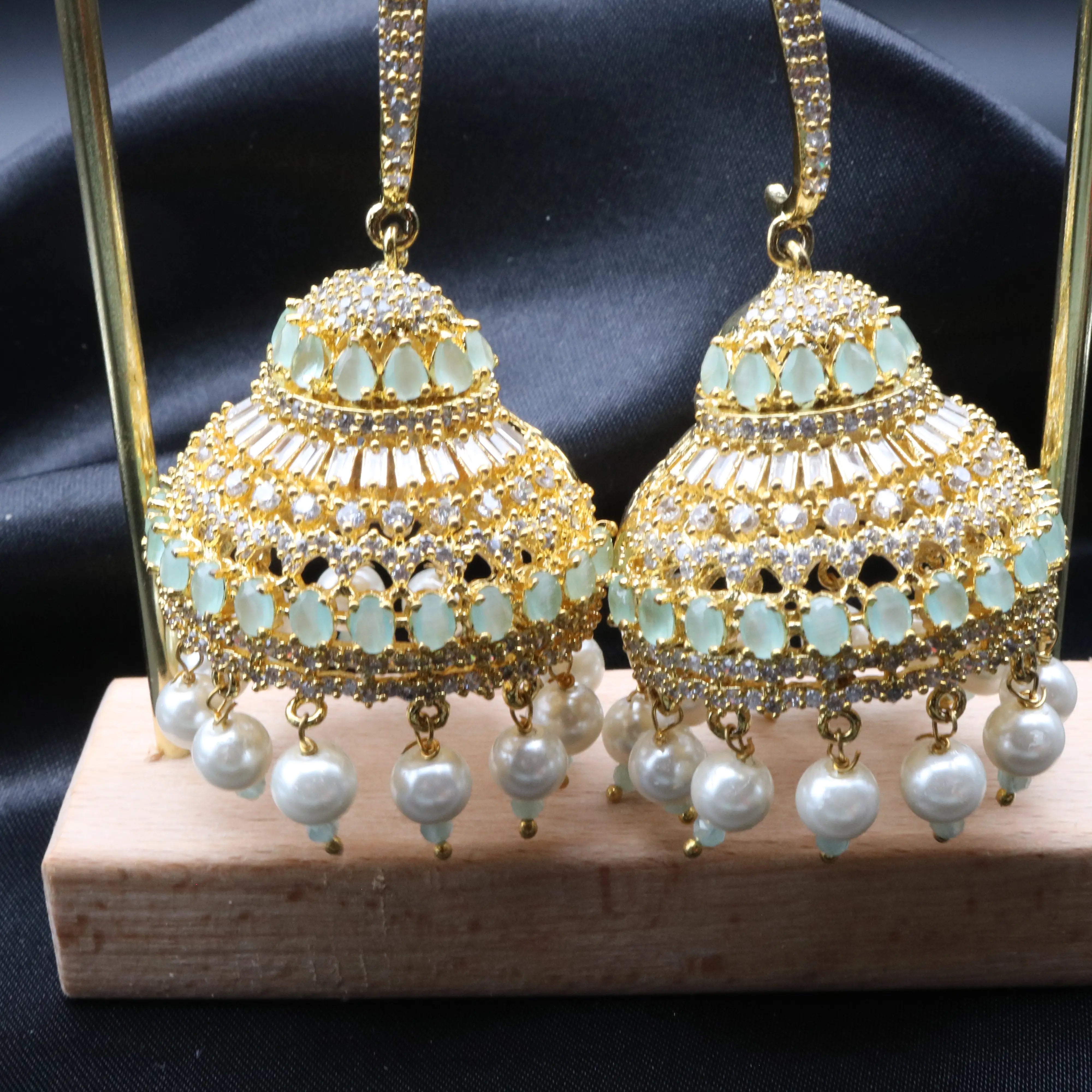 Jhumka part of Pakistani design jhumkay with jarao craftsmanship. Teal and clear gemstones with pearl accents providing an exquisite touch.