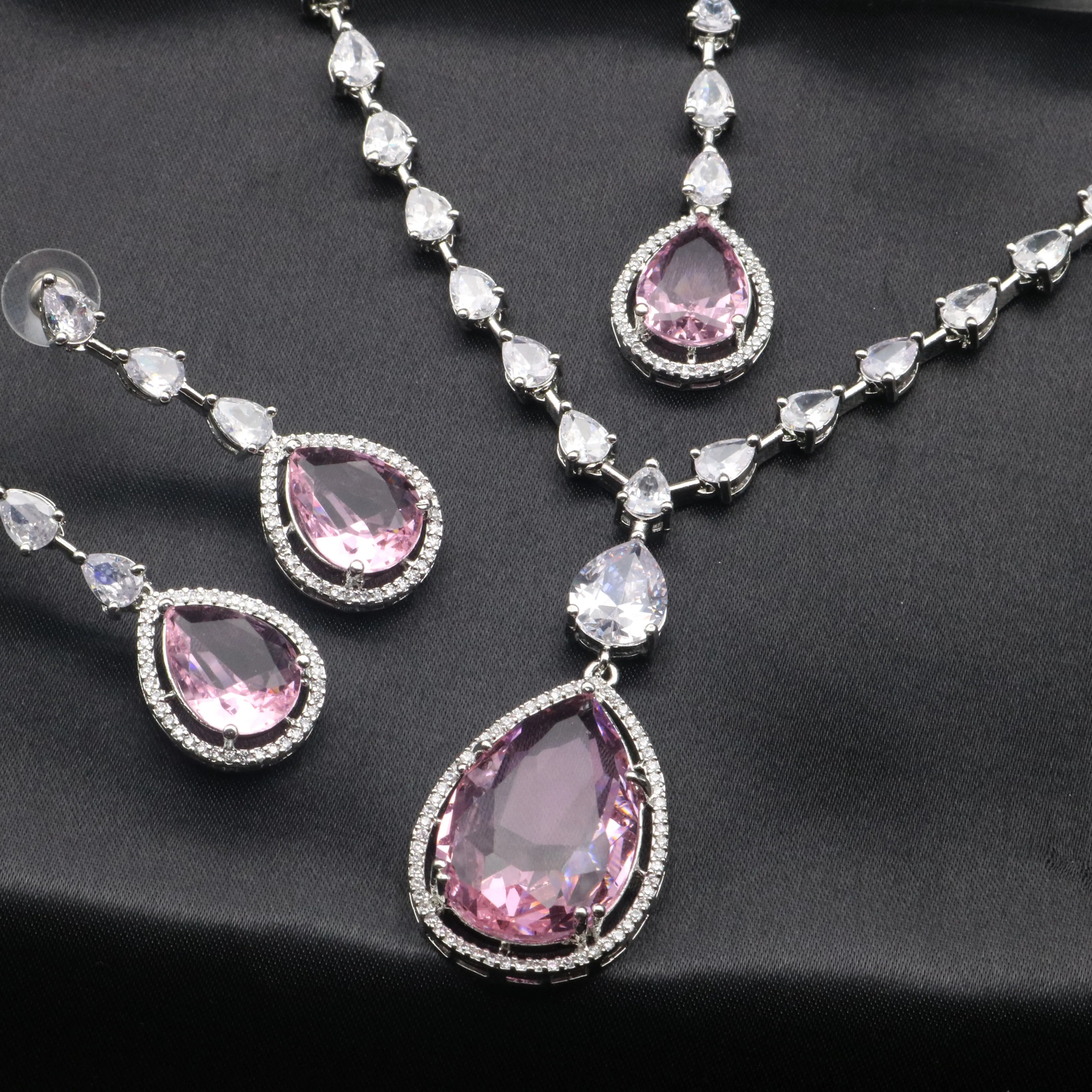 Blush pink gemstone necklace set with matching earrings and maang tikka, encrusted with American diamonds.