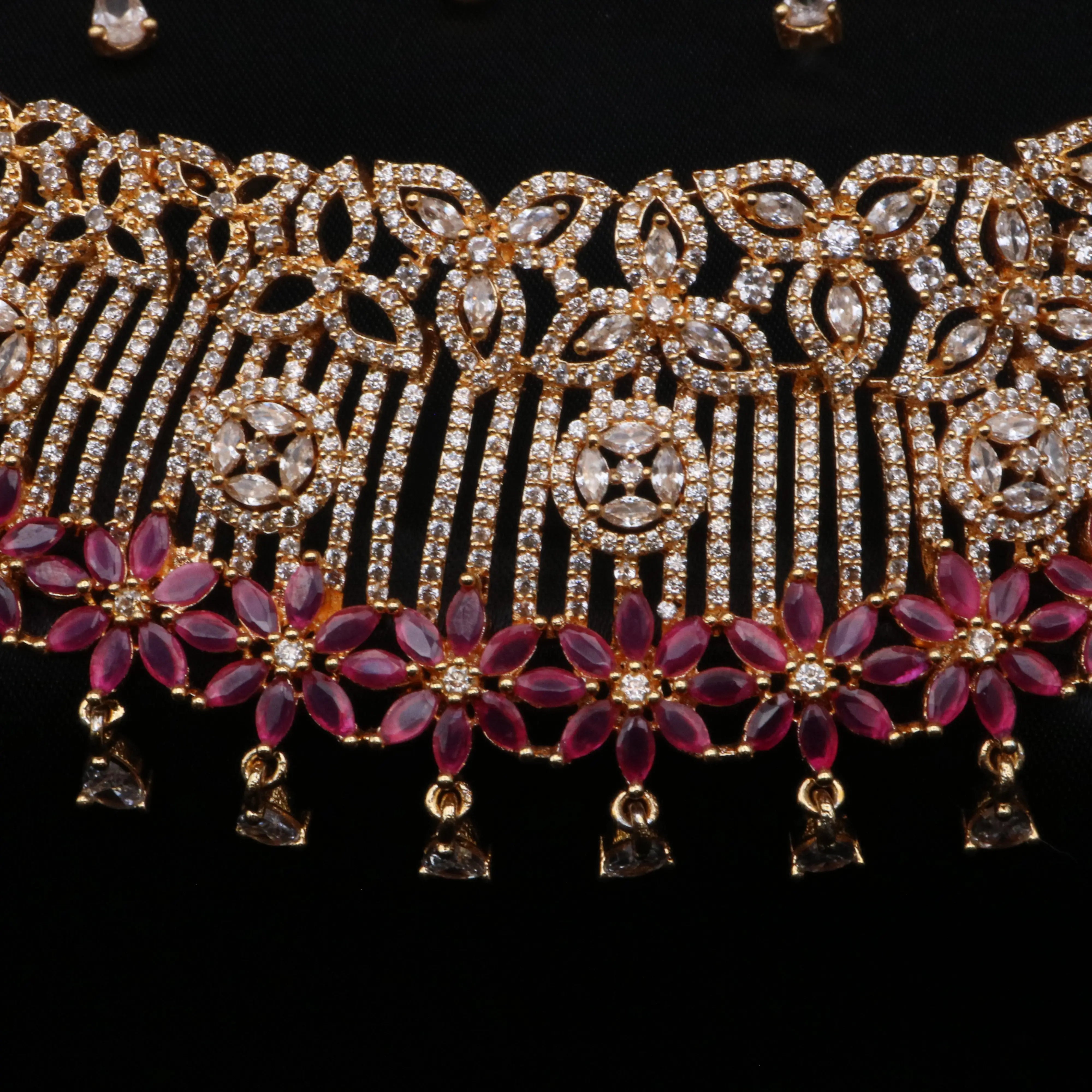 Close-up of the necklace's pink floral gemstone border and hanging CZ charms.