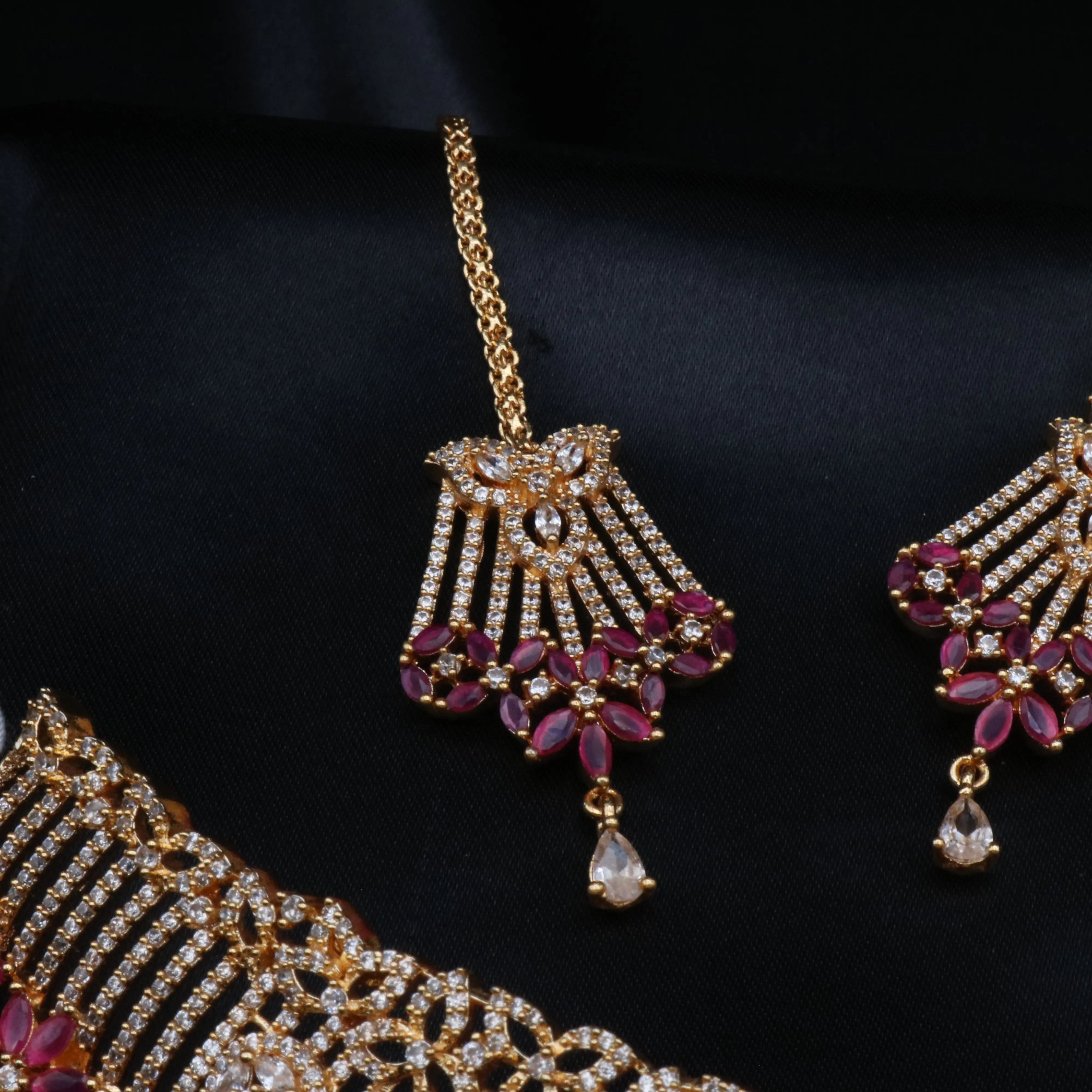 Maang tikka with ruby floral drops and American diamonds on gold base from the Cherry Blossom set.