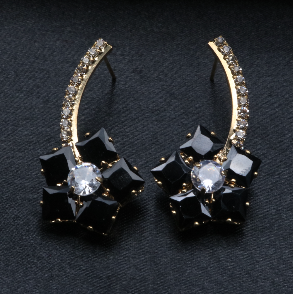 A pair of stainless steel and gold-plated earrings with black and clear American diamonds.