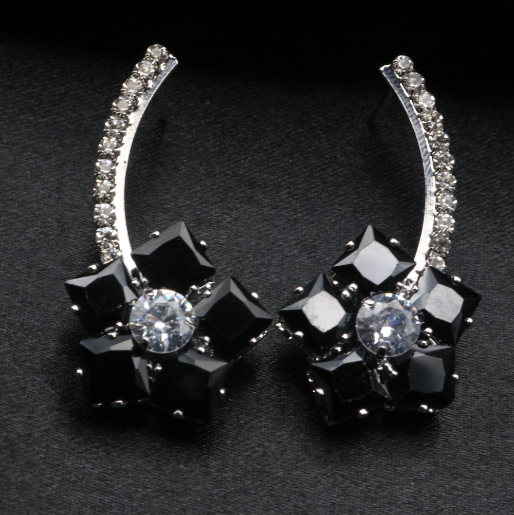 A pair of stainless steel and gold-plated earrings with black and clear American diamonds.