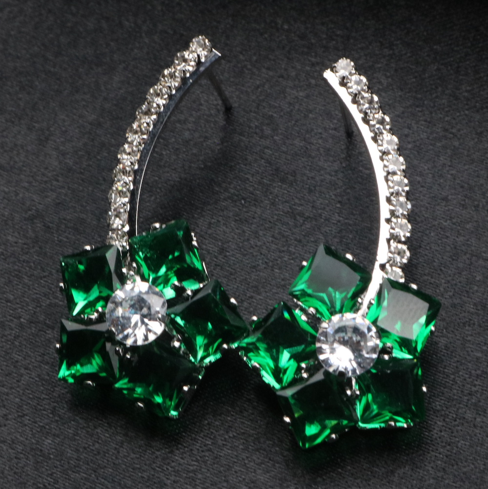 A pair of stainless steel and gold-plated earrings with green and clear American diamonds.