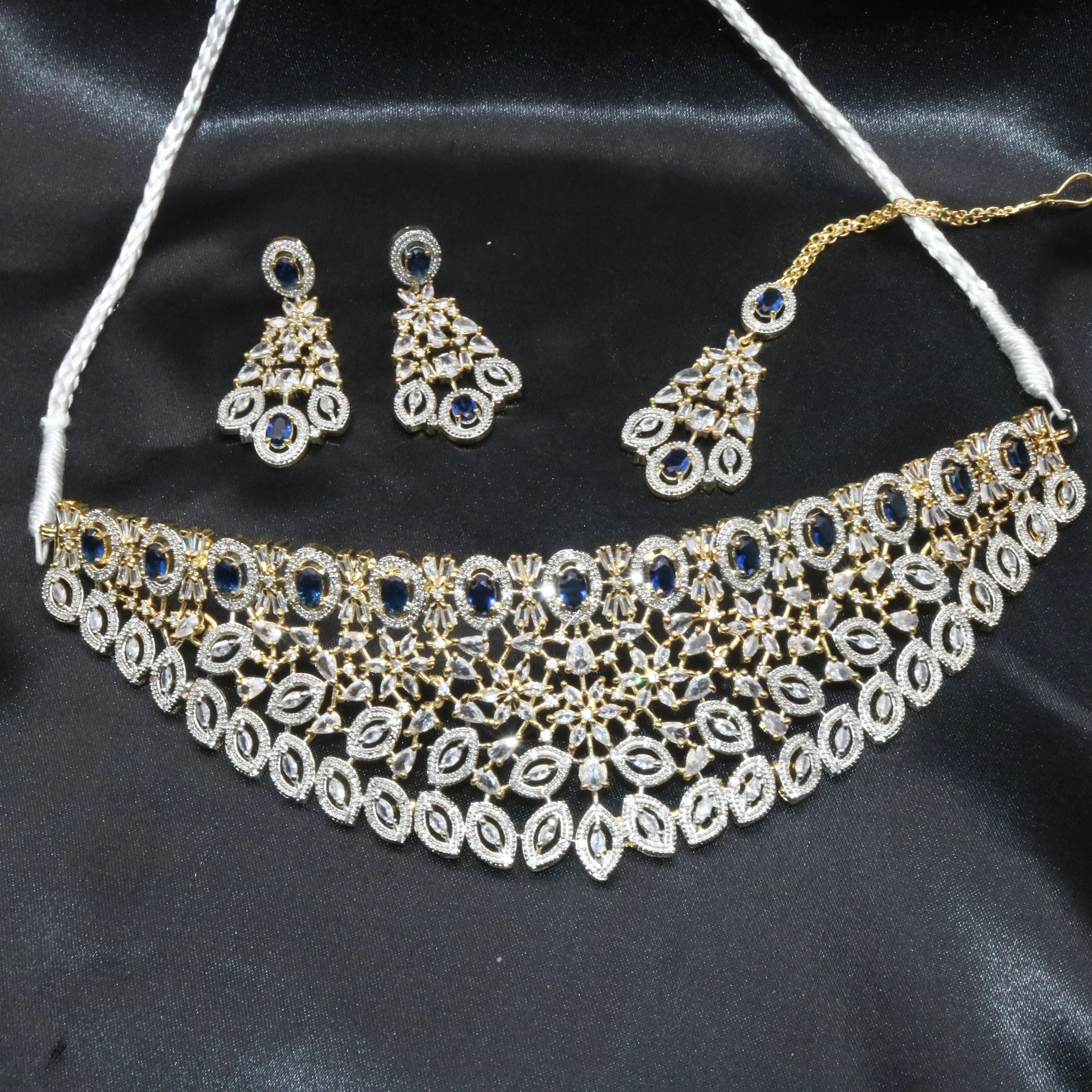 Complete Fairy set in blue variant including choker necklace, earrings, and teeka placed on satin background.