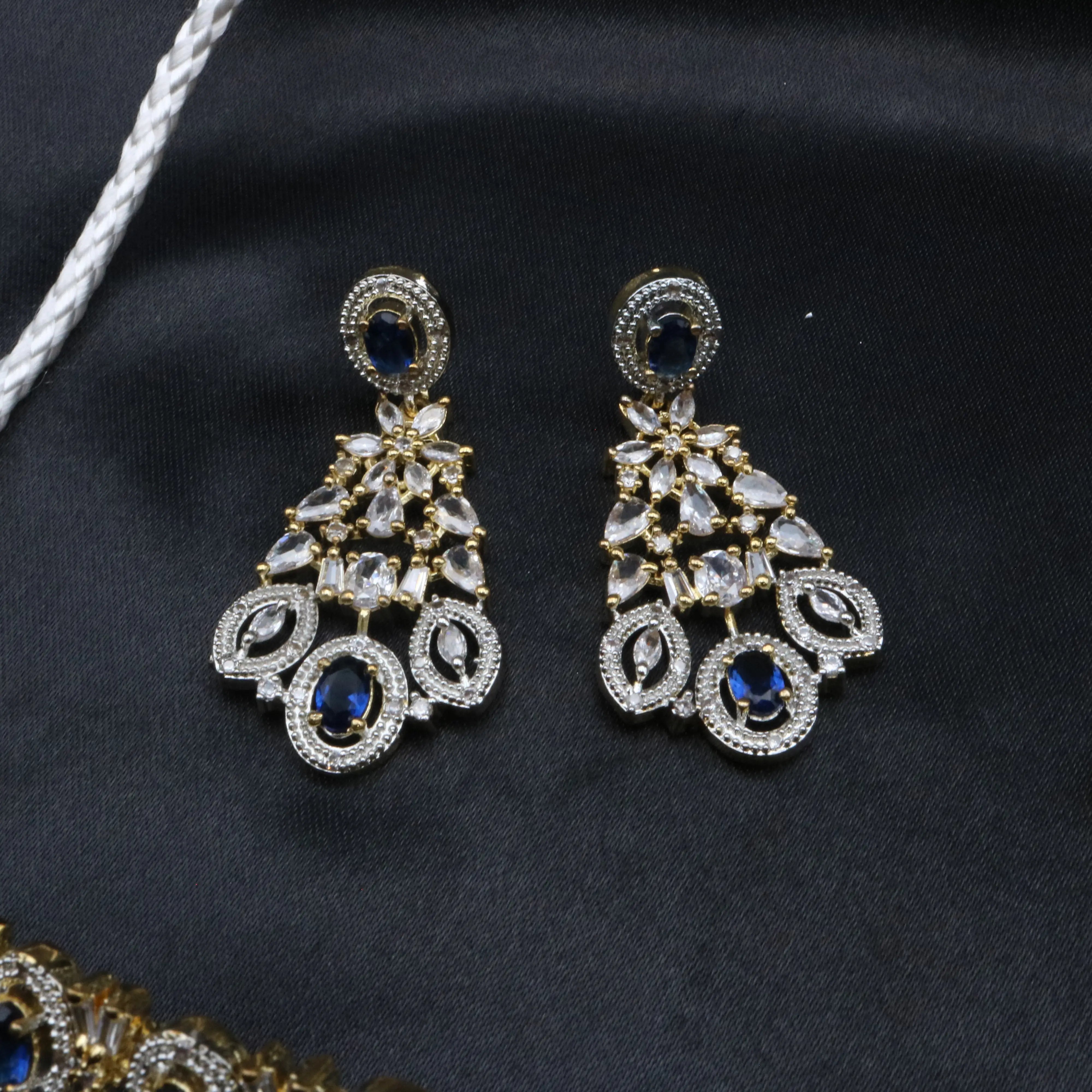 Front view of Fairy earrings in the blue variant with American diamonds and teardrop designs.