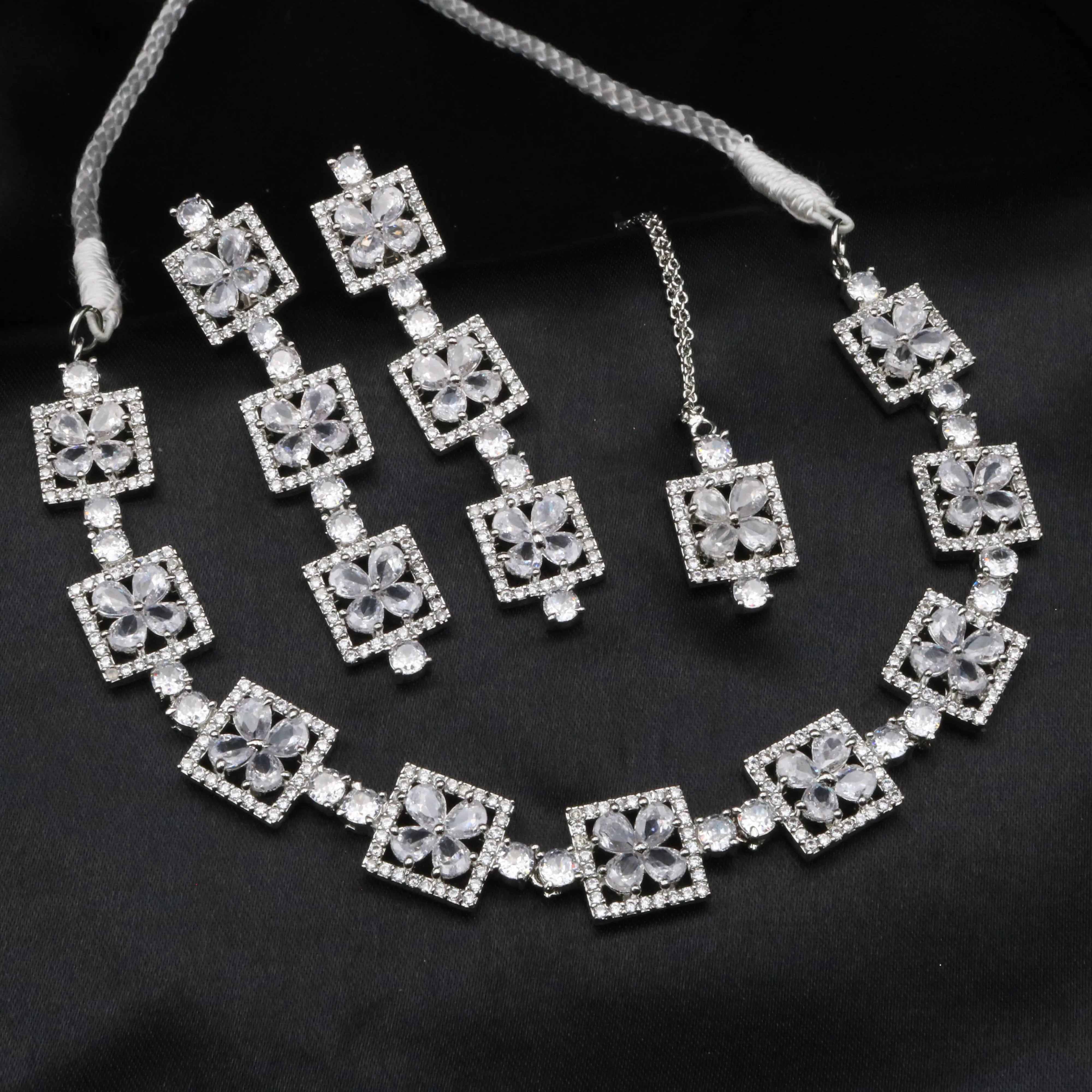Fleur necklace set in white with petal-shaped CZ stones and silver square frame design.