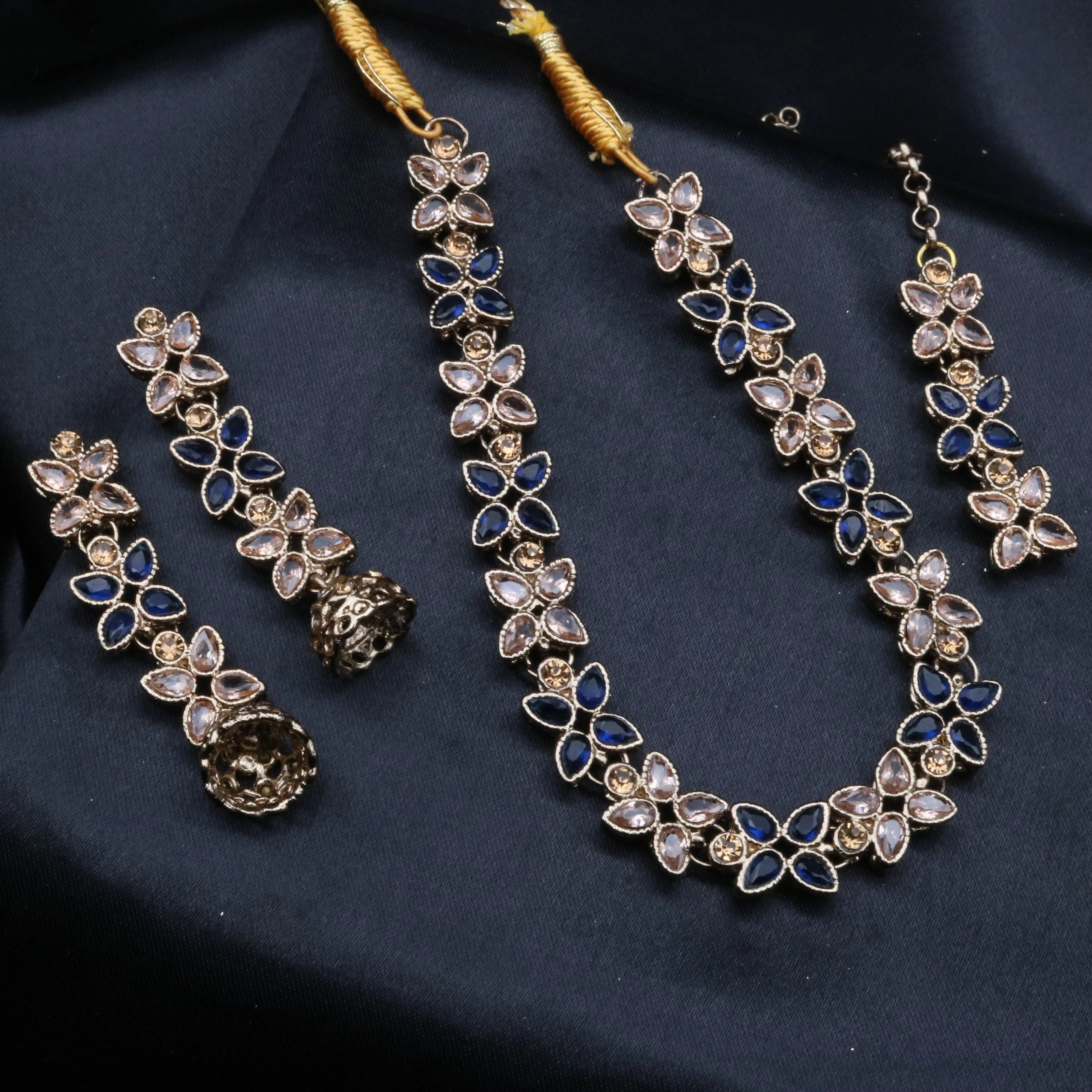 Full navy CZ Flora necklace set on dark fabric, featuring marquise floral stones with intricate detailing.
