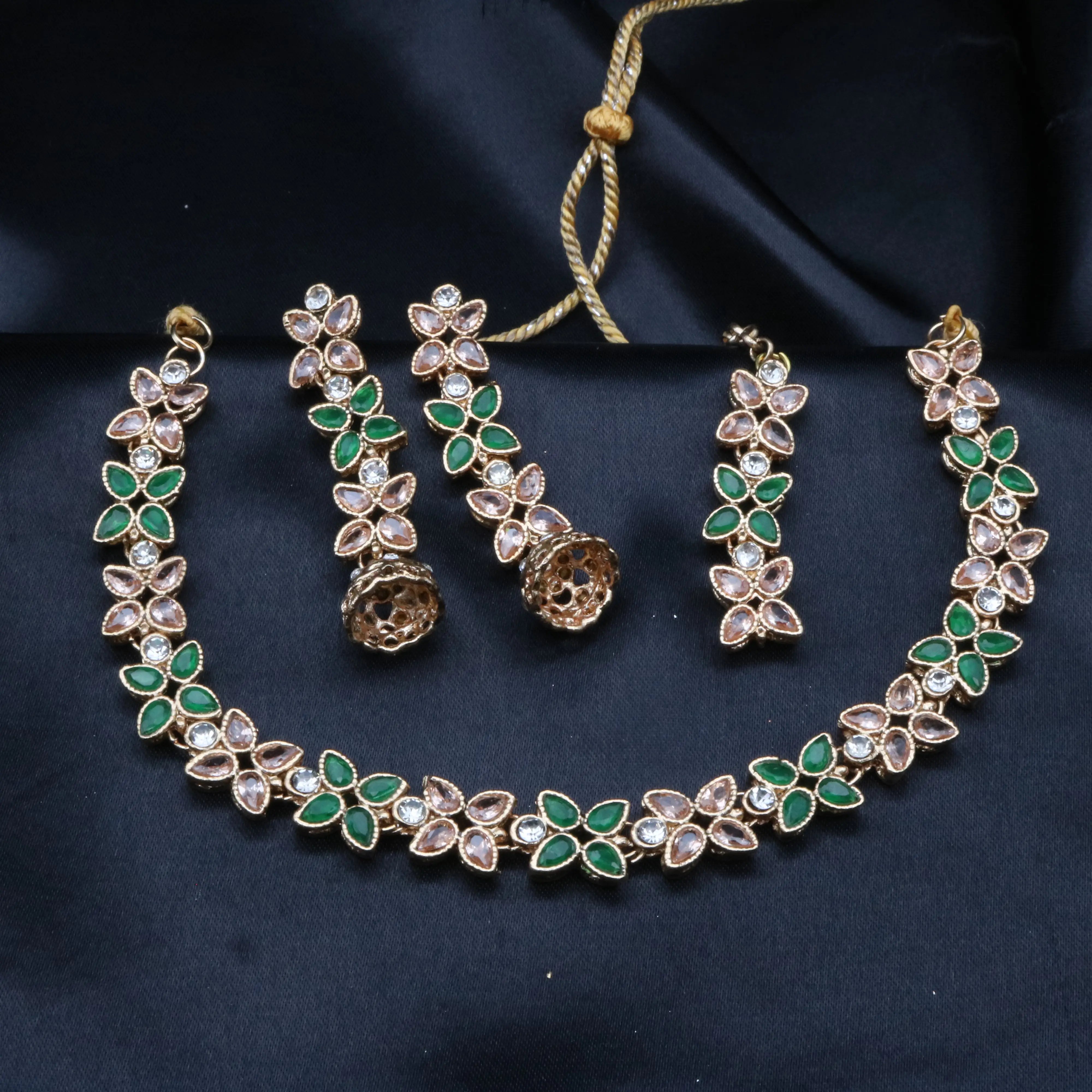 Flora green and champagne stone necklace set with floral CZ design, displayed on dark background.
