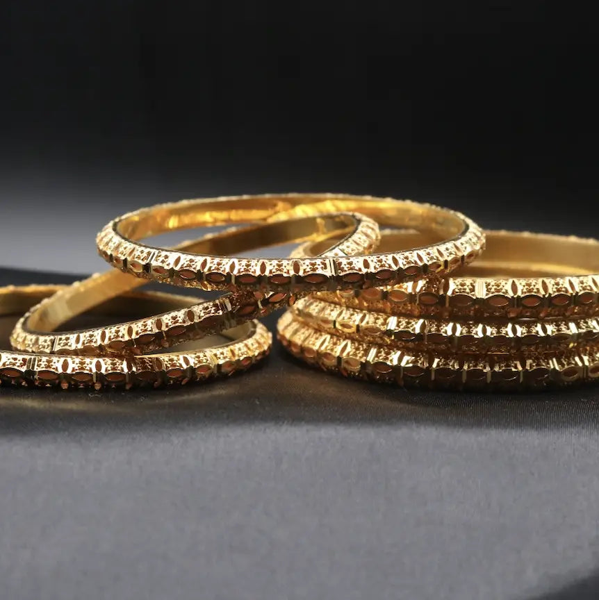 Gold bangles handcrafted in Pakistan with geometric and linear accents