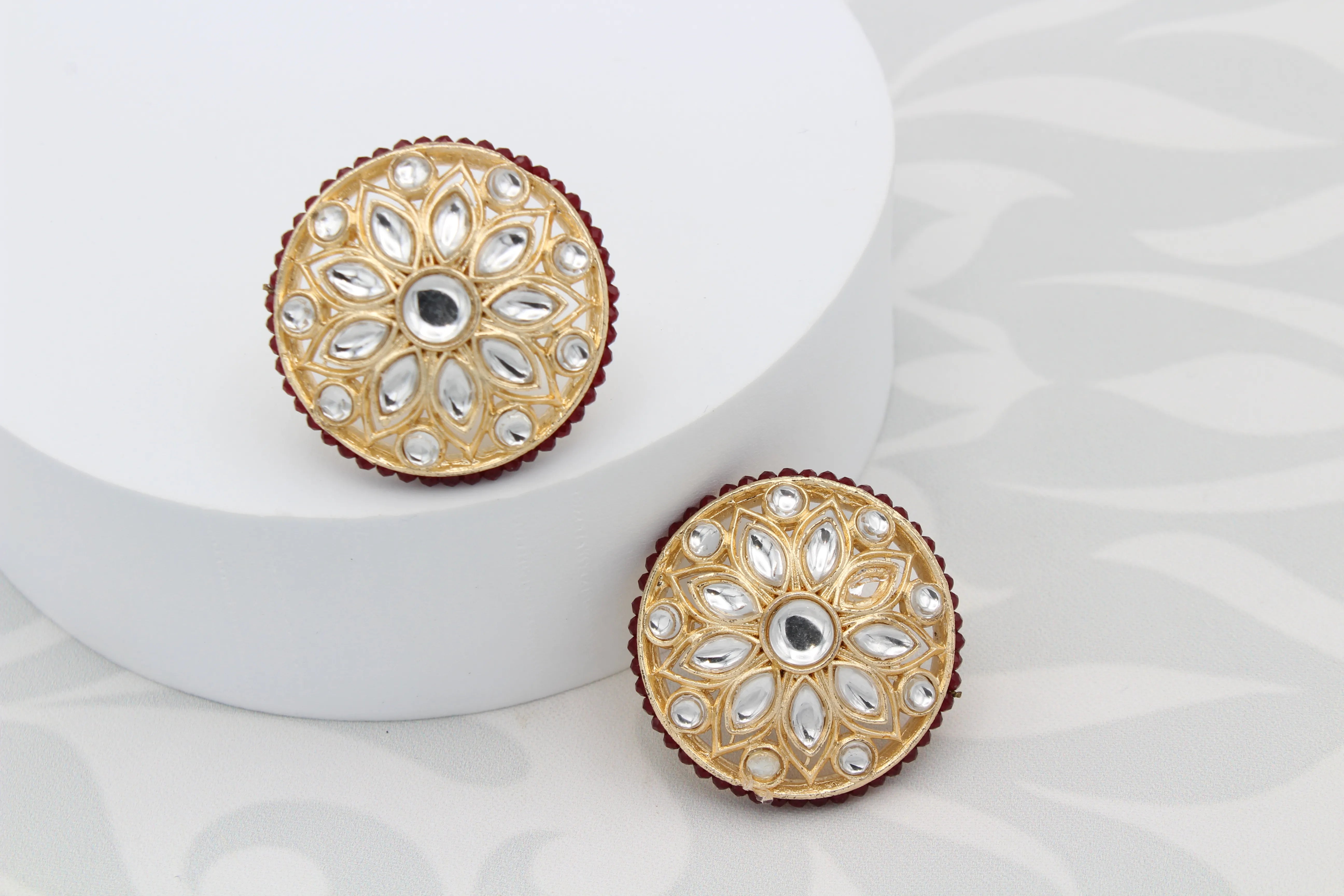 Gold-plated and waterproof earrings with gemstones on a white background
