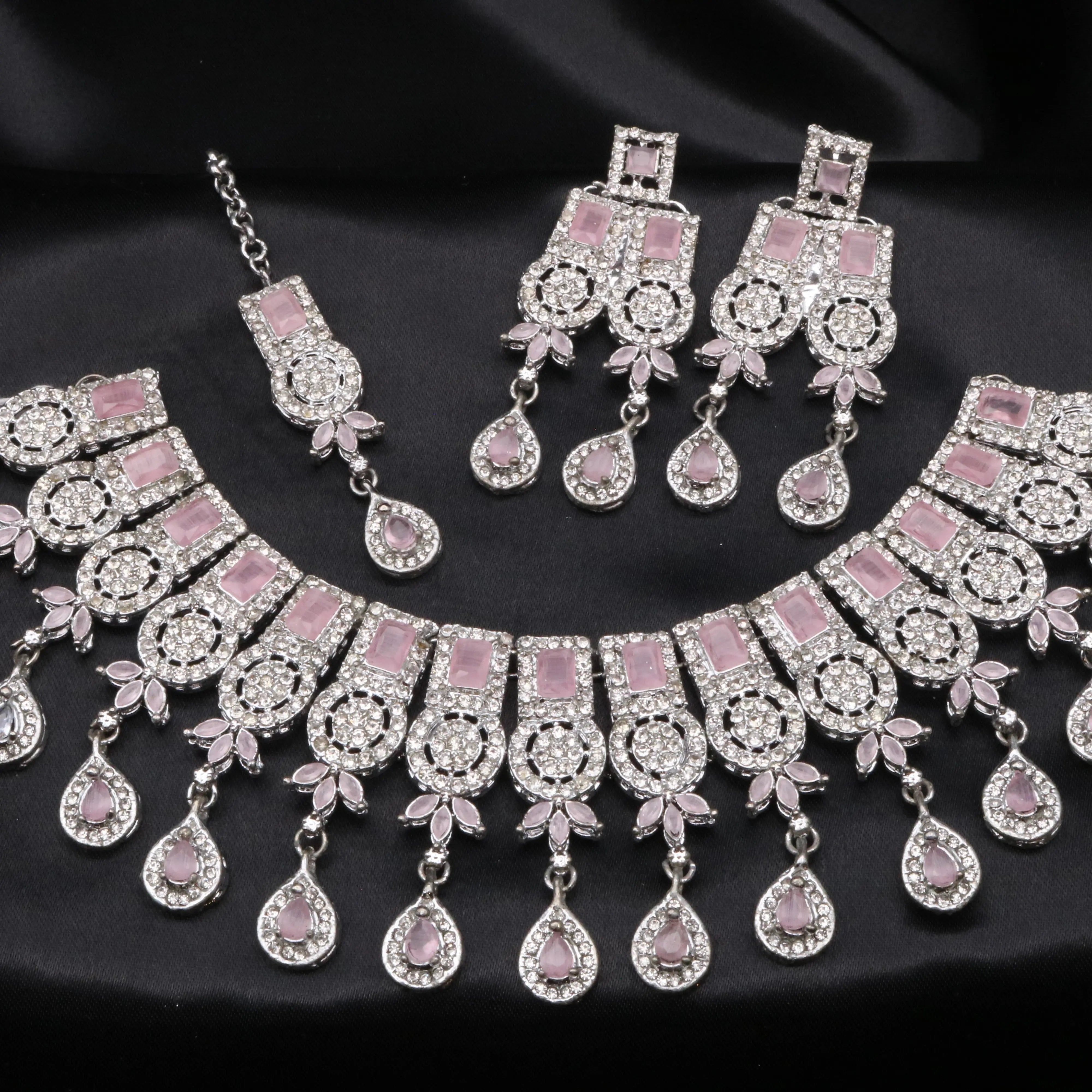 Blush pink Ishq necklace set with light pink gemstones and CZ accents on silver base.