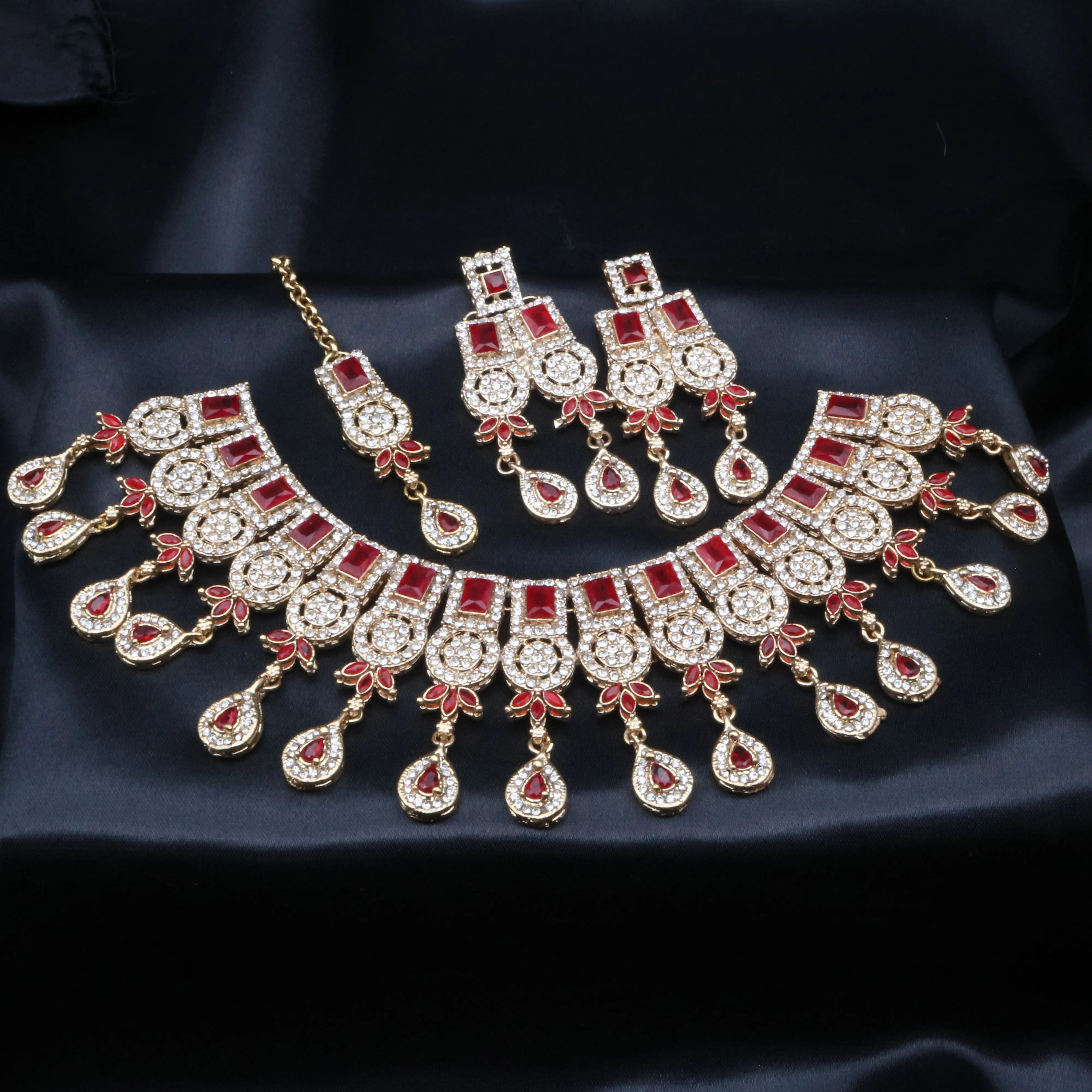 Ruby red Ishq necklace set with vibrant red stones and intricate detailing in a gold setting.