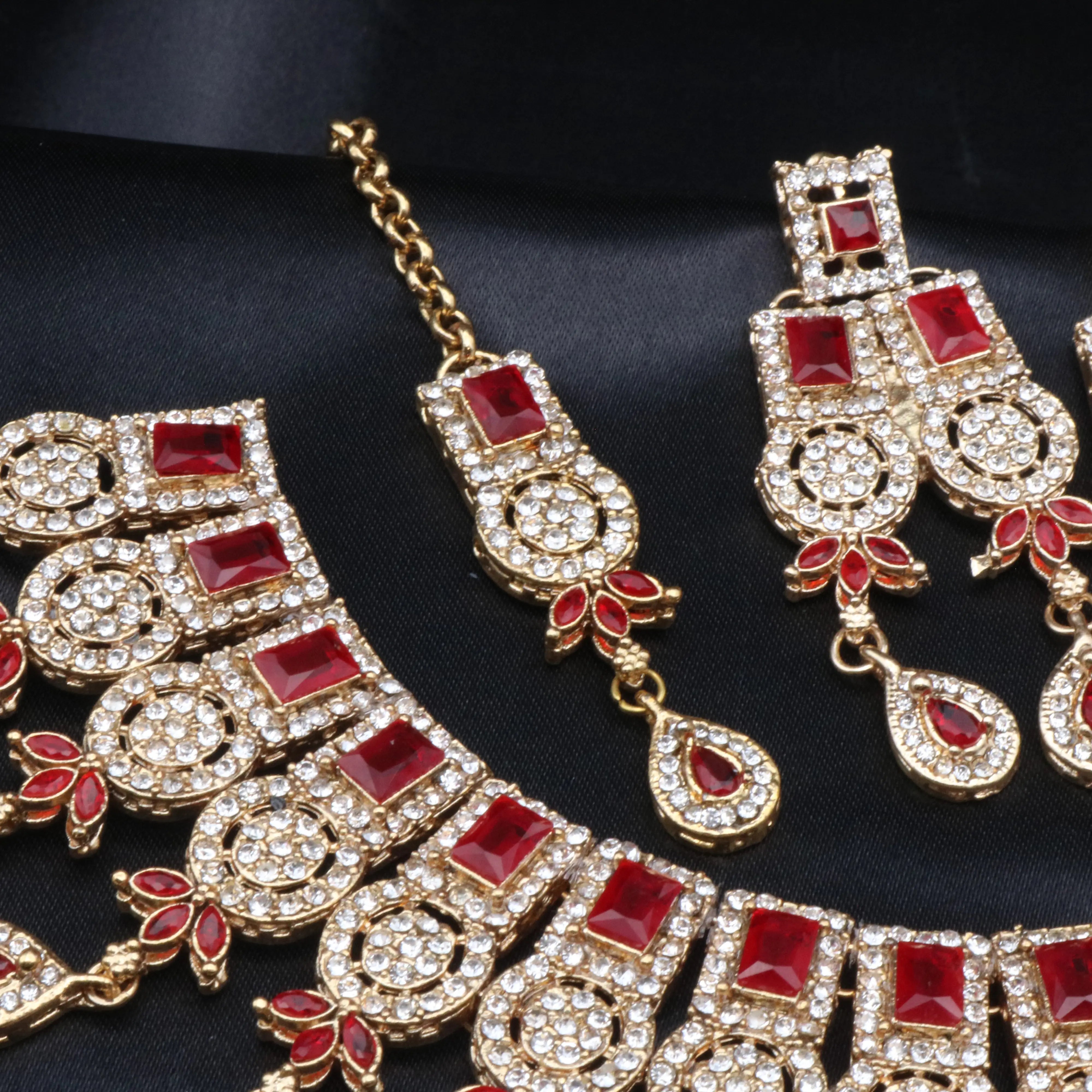 Side view of Ishq red variant earrings and tikka showing delicate craftsmanship.