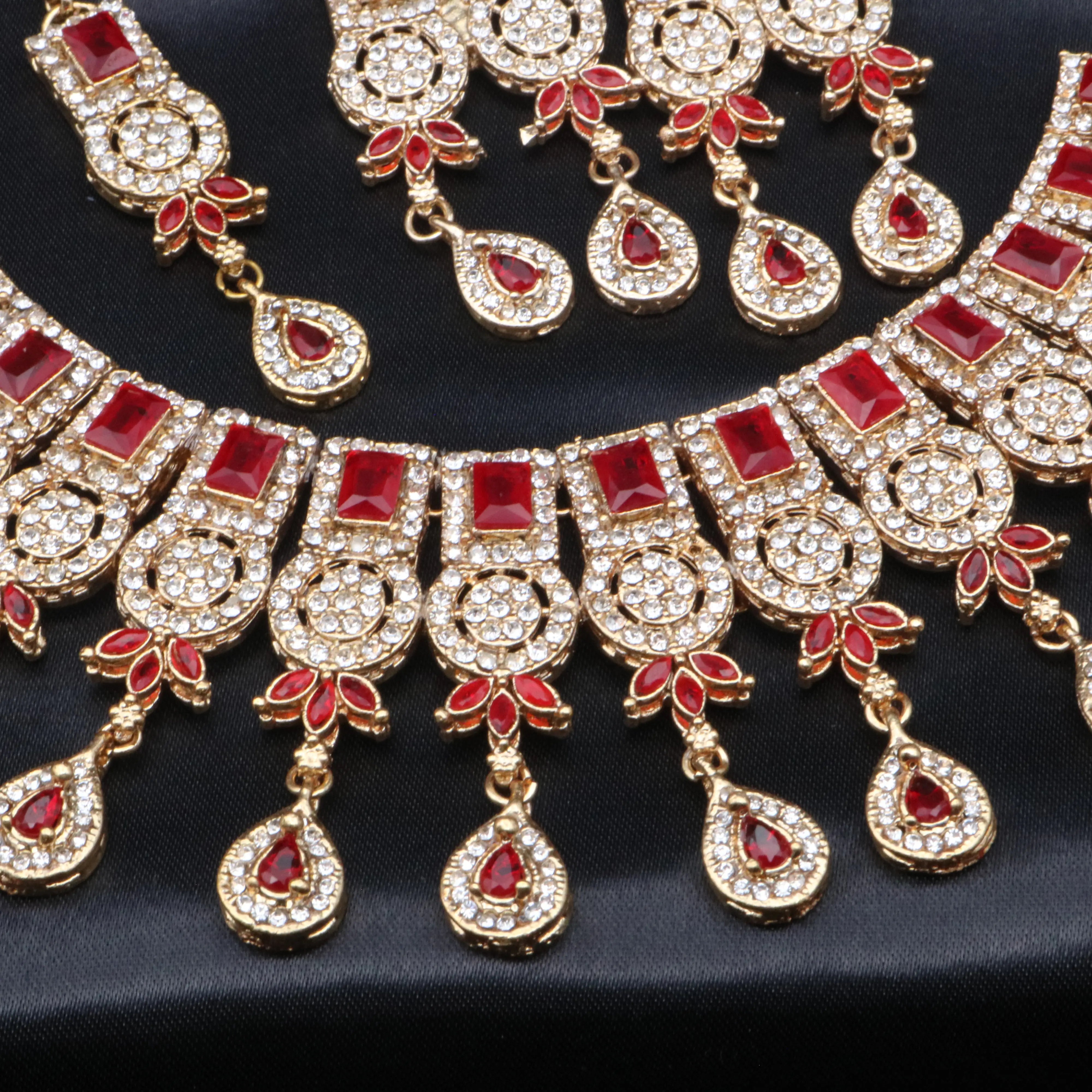 Top angle of Ishq red variant highlighting deep red gemstones against gold framework.