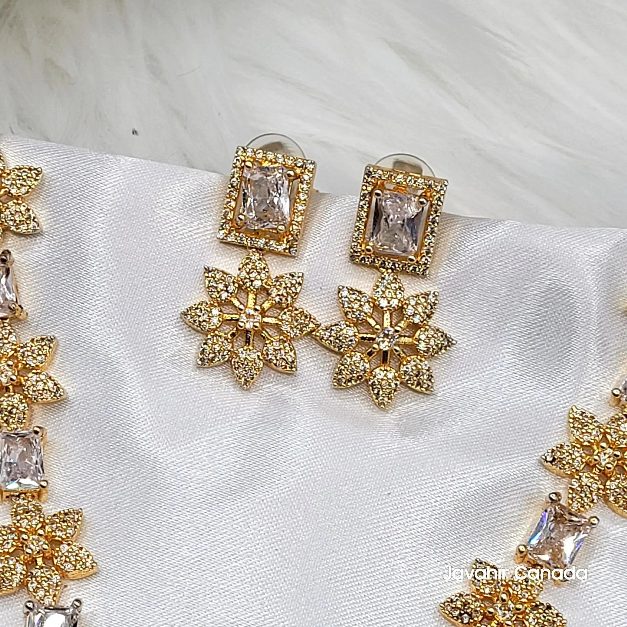 Pair of drop earrings from JV154 set featuring floral motif and sparkling cubic zirconia.