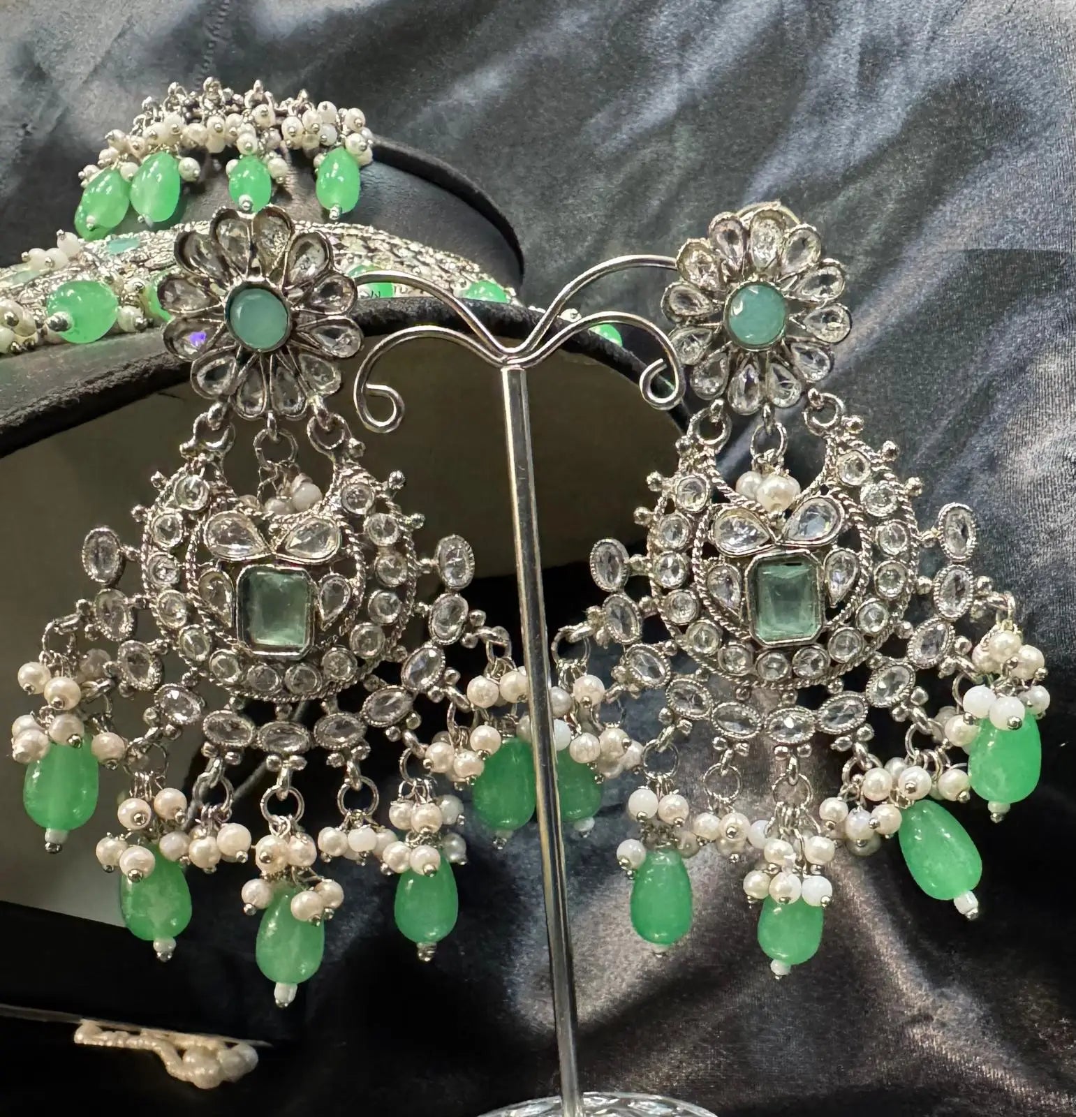 Close-up of chandbali earrings from JV157 set with silver kundan work, green beads, and pearl accents.