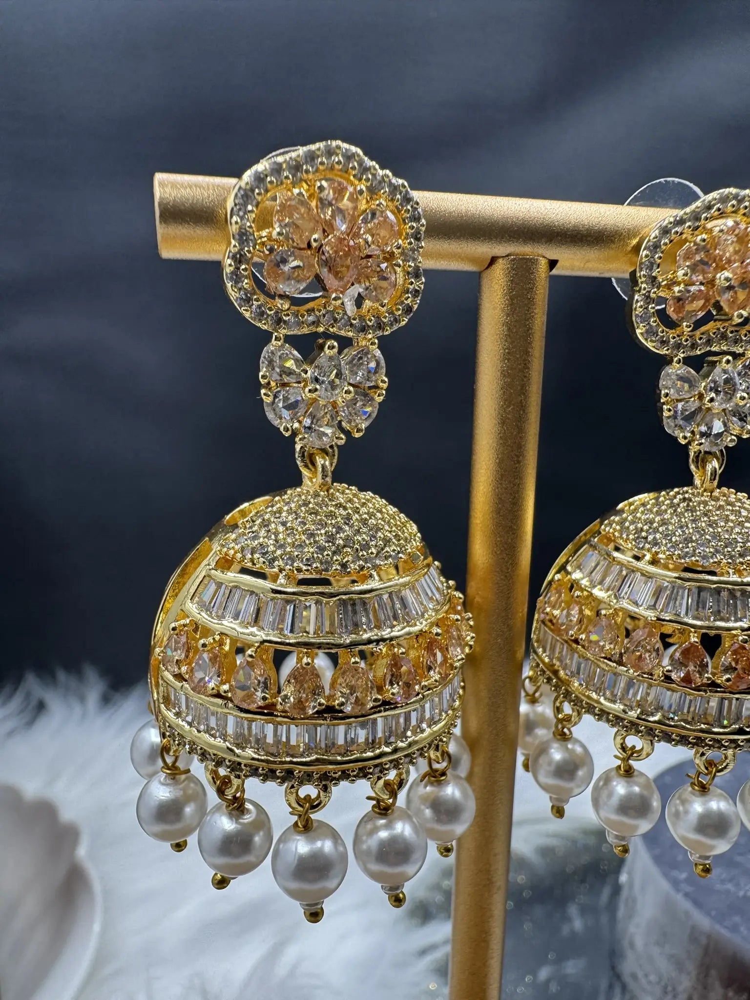 single jhumka view of Pakistani design intricate Jhumka with nano zarcon and jarao craftsmanship. They are gold plated and waterproof.