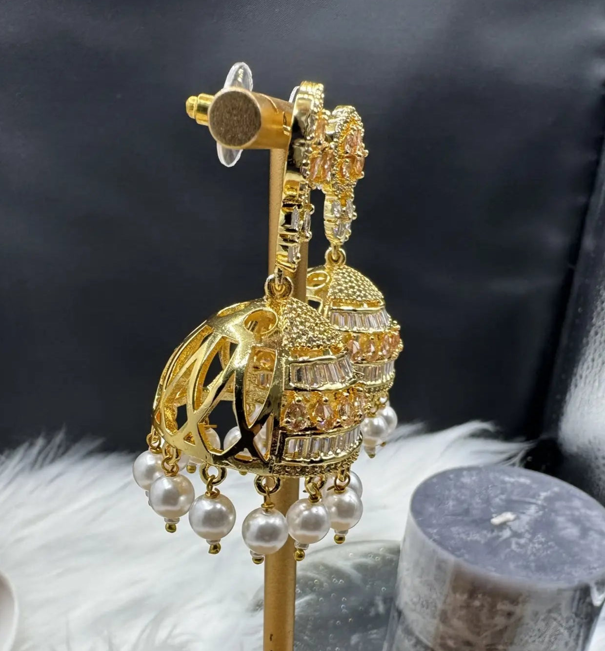 side view of Pakistani design intricate Jhumka with nano zarcon and jarao craftsmanship. They are gold plated and waterproof.