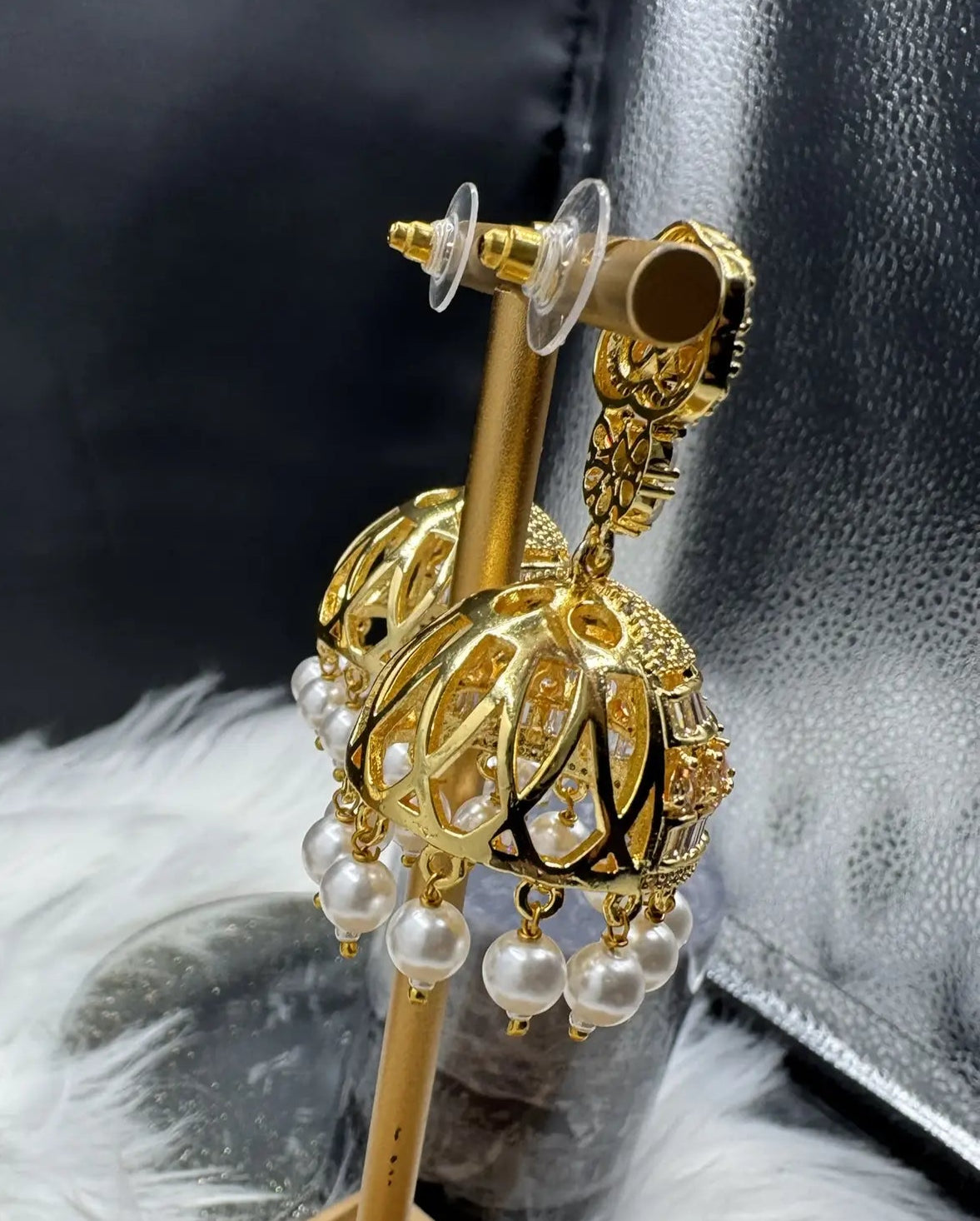 back side view of Pakistani design intricate Jhumka with nano zarcon and jarao craftsmanship. They are gold plated and waterproof.