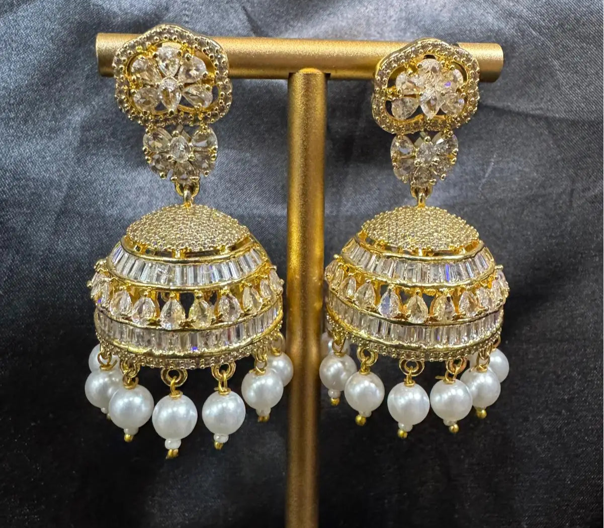 A pair of Pakistani design intricate Jhumkas with nano zarcon and jarao craftsmanship. They are gold plated and waterproof.