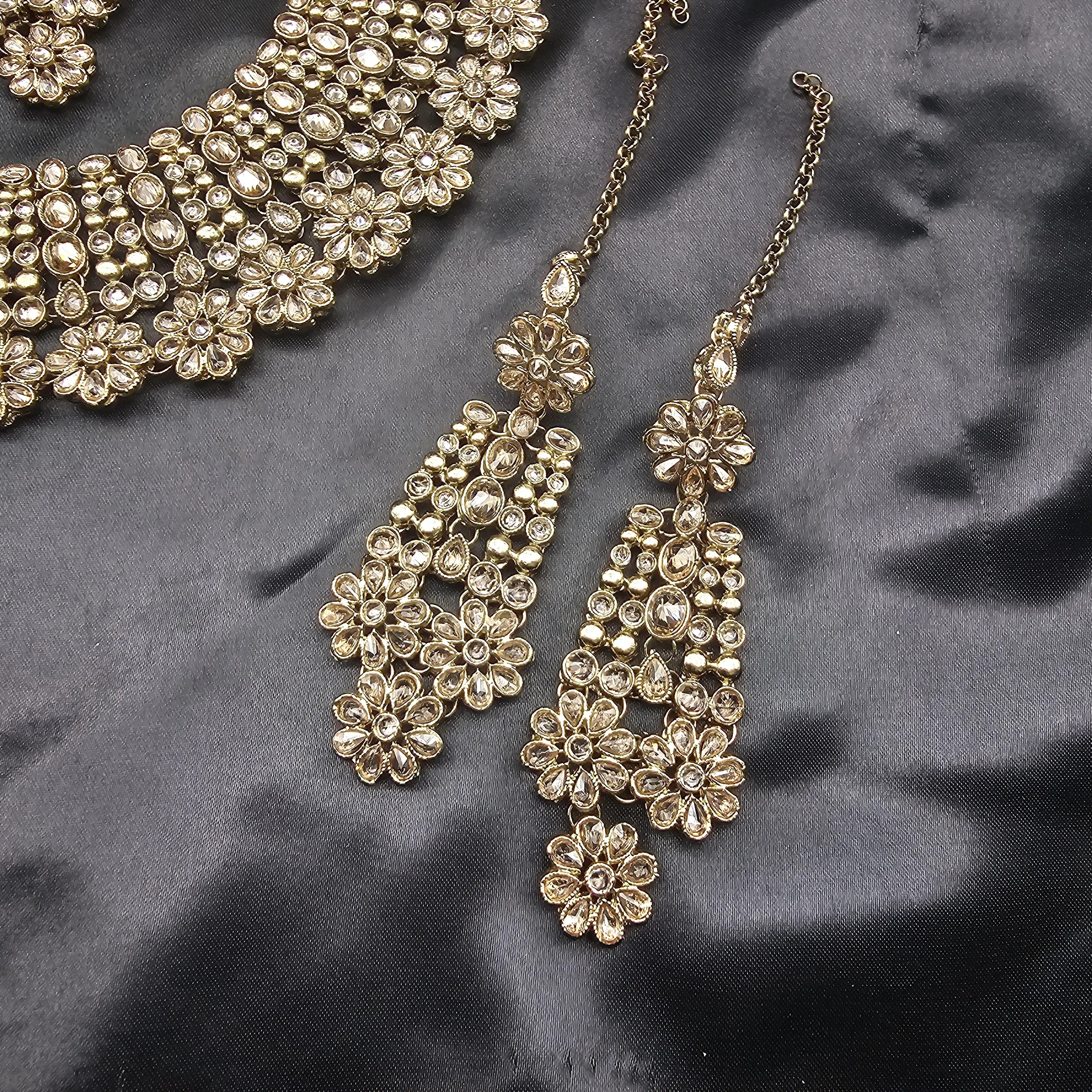 Detailed view of Magnolia earrings with layered floral elements and dangling structure.