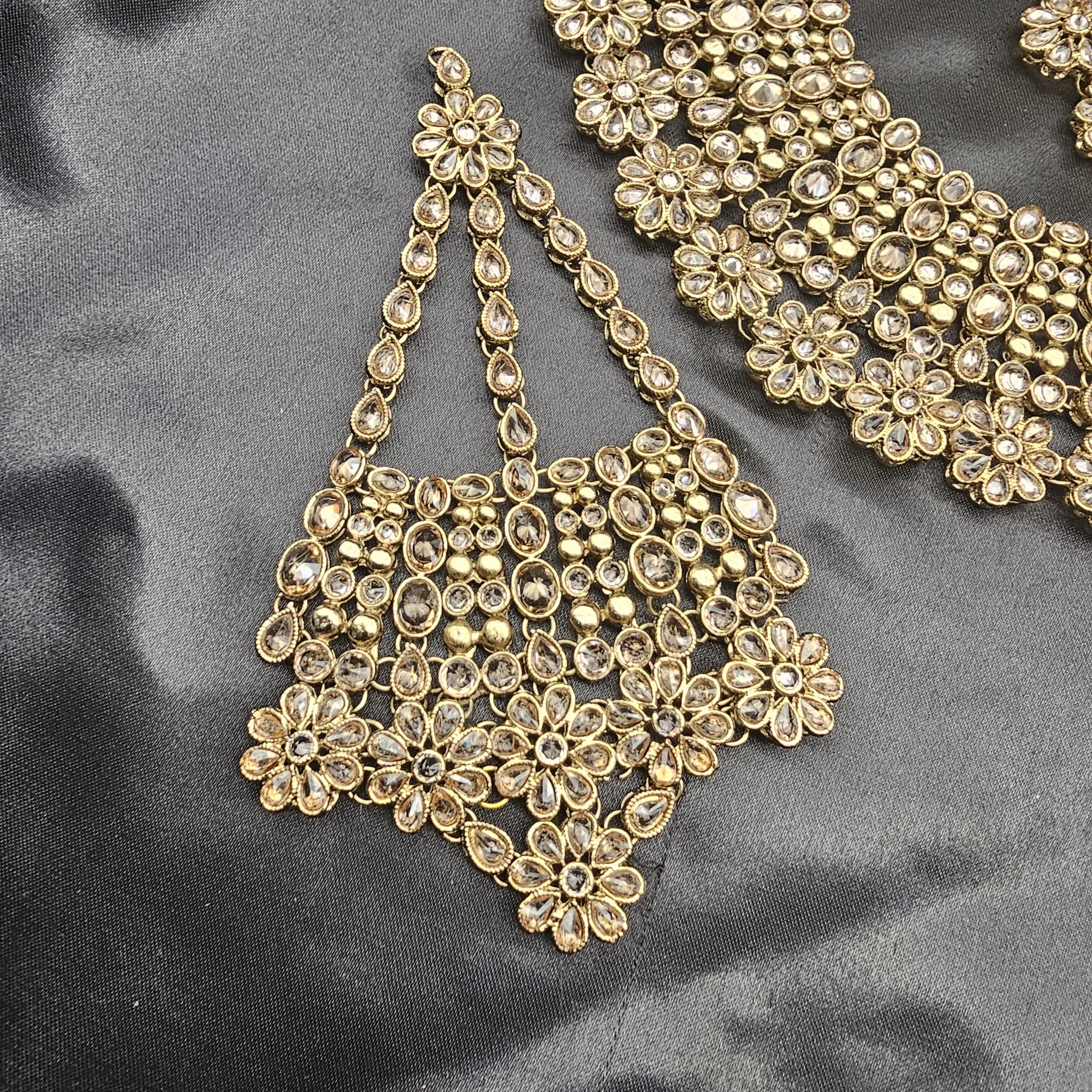 Close-up of Magnolia bridal jhoomer showcasing floral Kundan-style stones and antique gold finish.