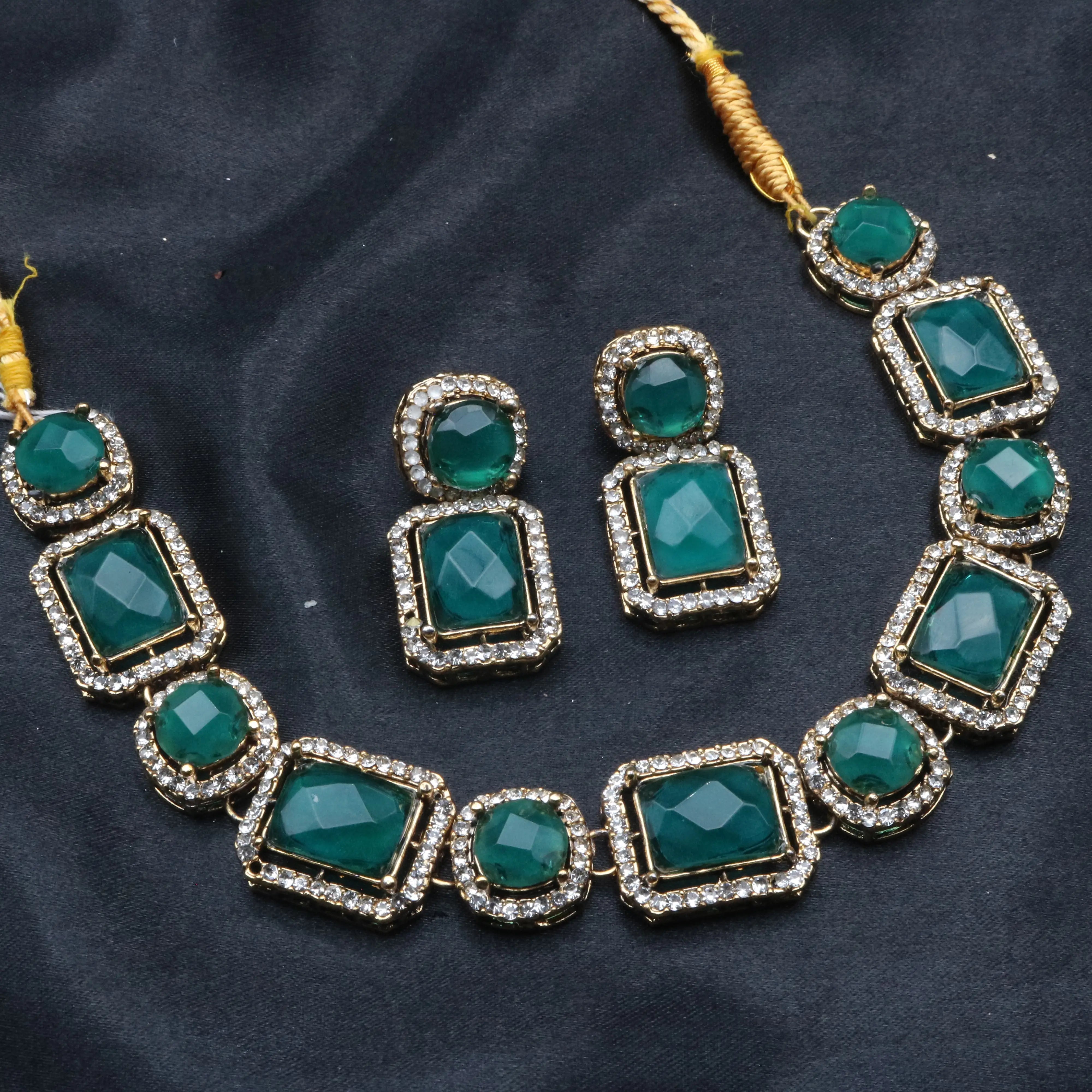 Maharaj emerald green necklace set with gold base and CZ halo on black fabric