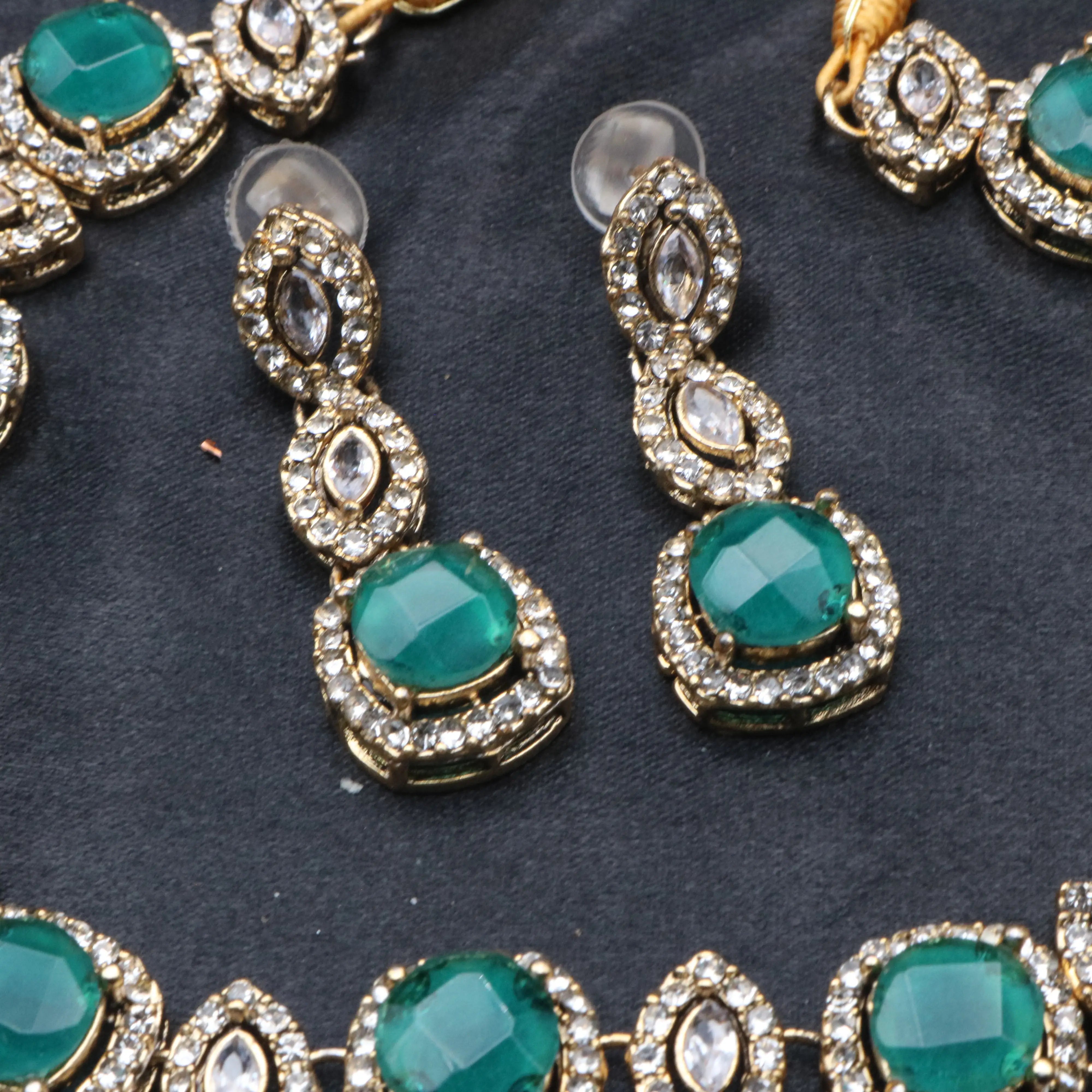 Matching emerald green Maharani earrings with halo-set CZ stones and gold-plated base