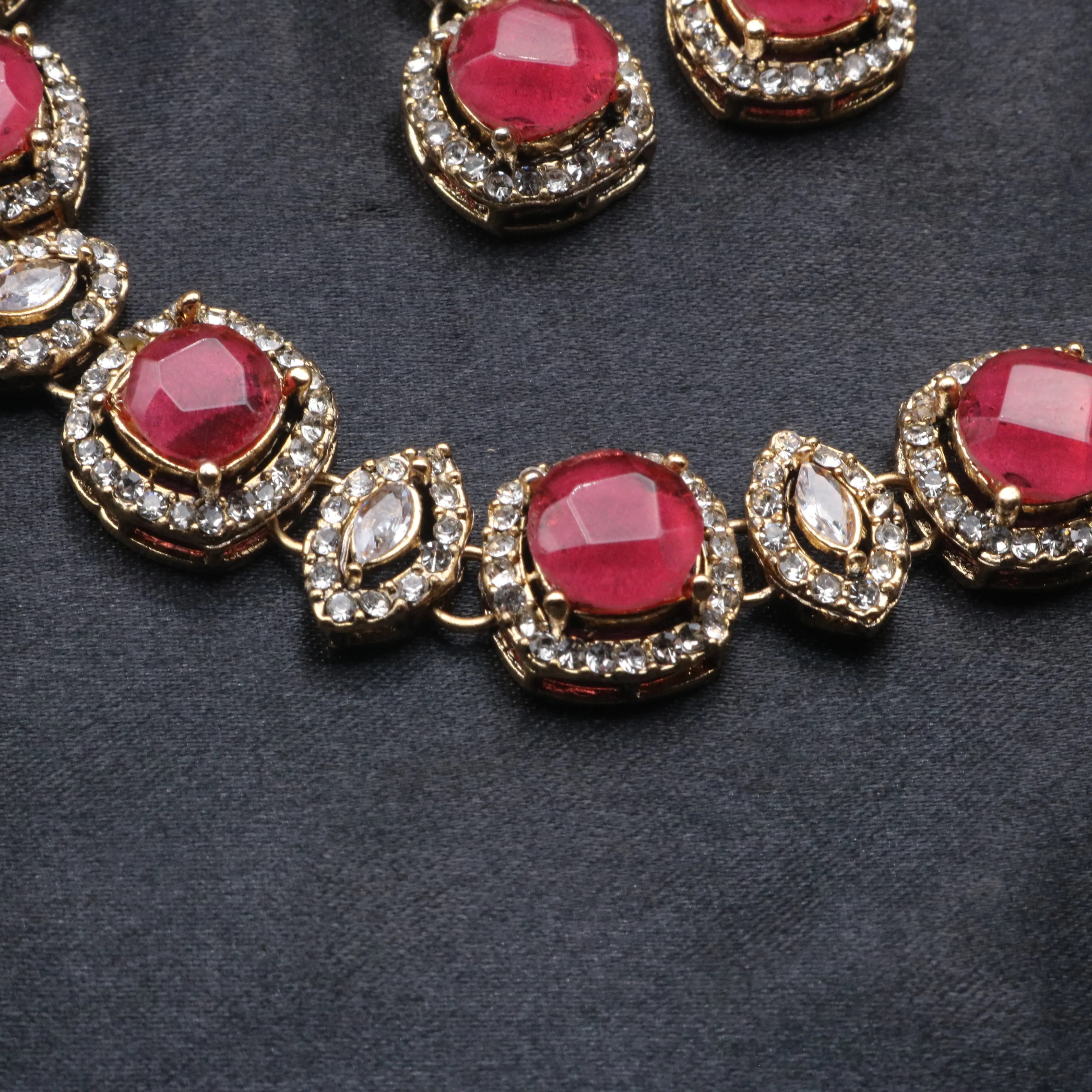Detailed view of ruby Maharani necklace showcasing round and marquise CZ combination