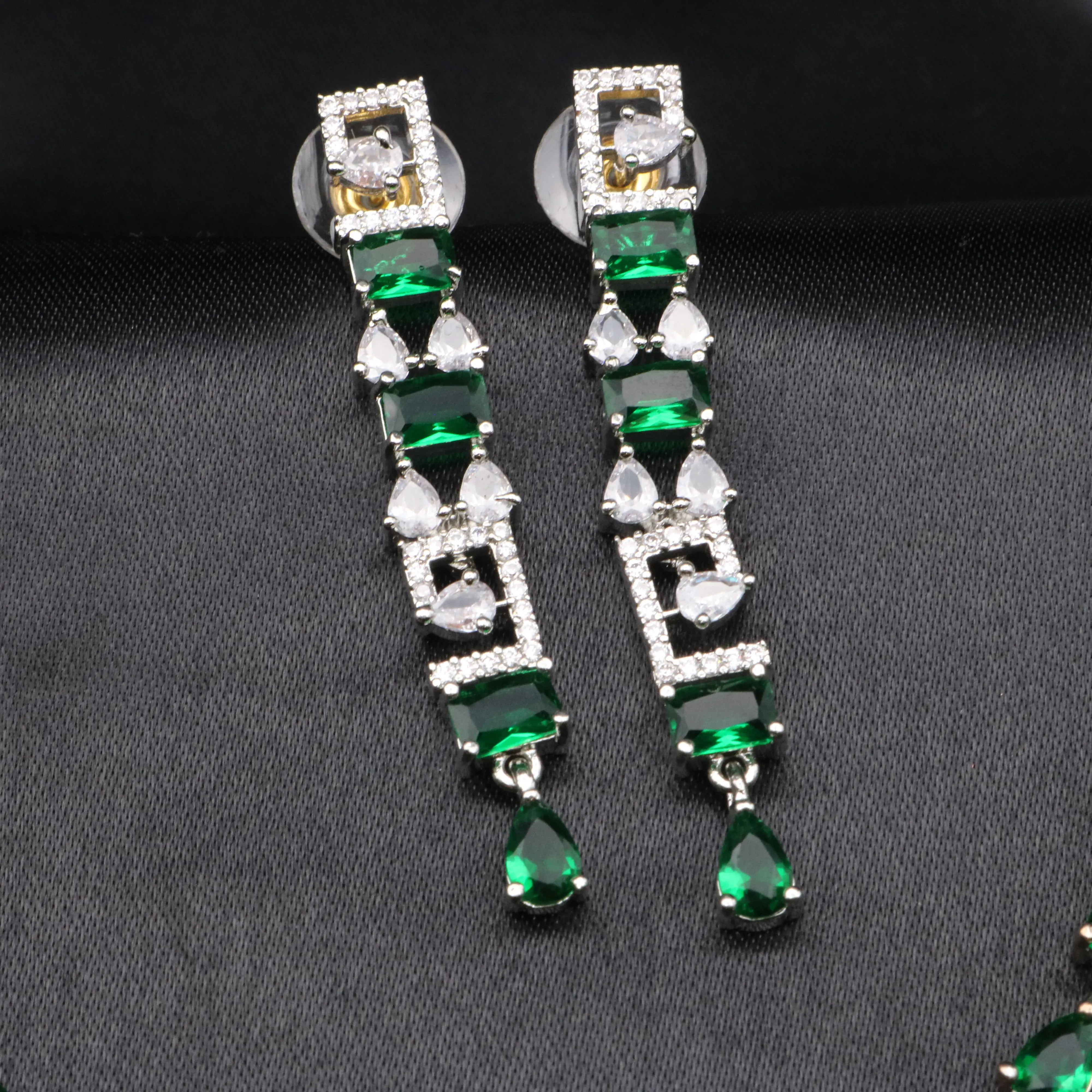 Majesty earrings in emerald green with pear-shaped drops and square CZ accents.