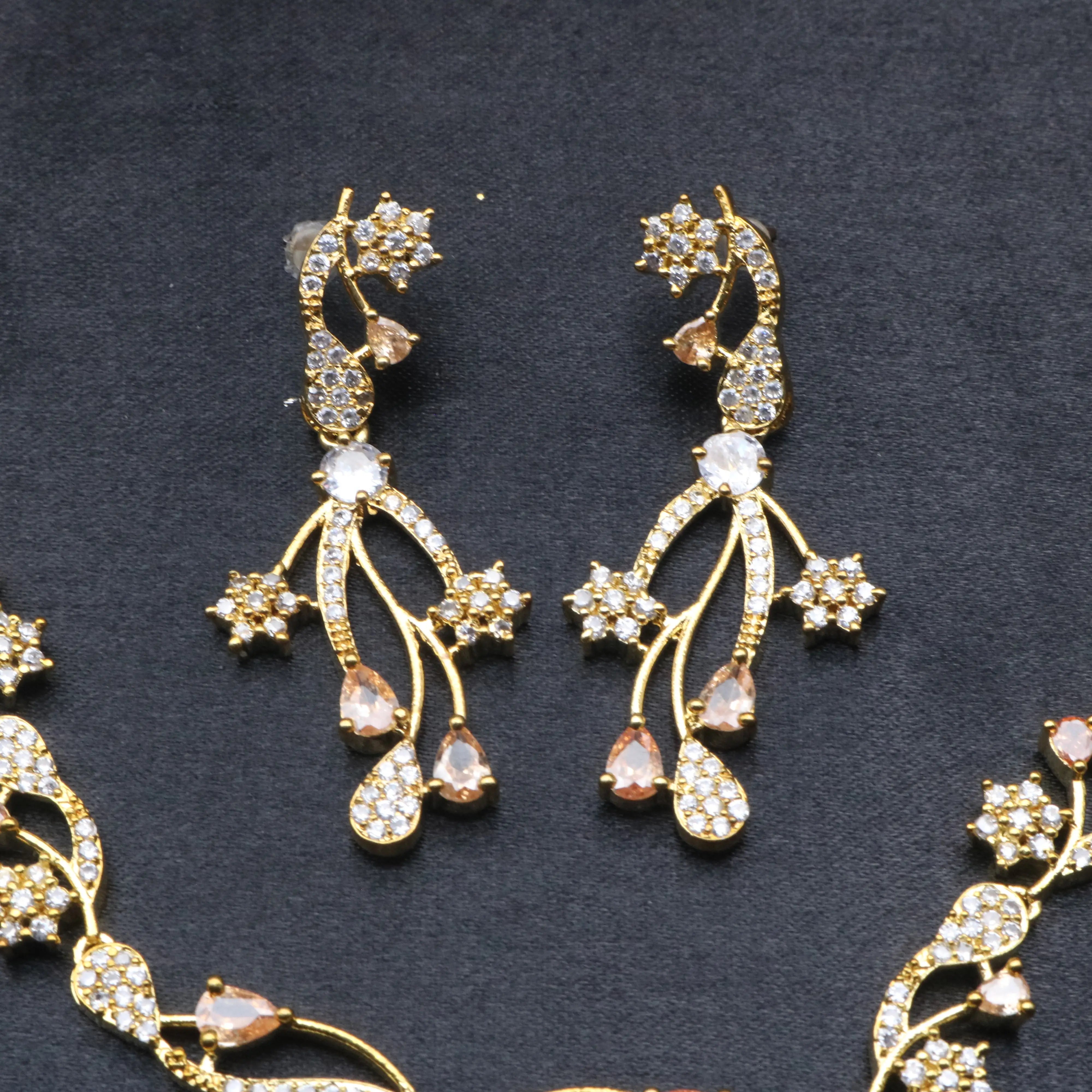 Close-up of Opera earrings with American diamonds and peach teardrop CZ accents