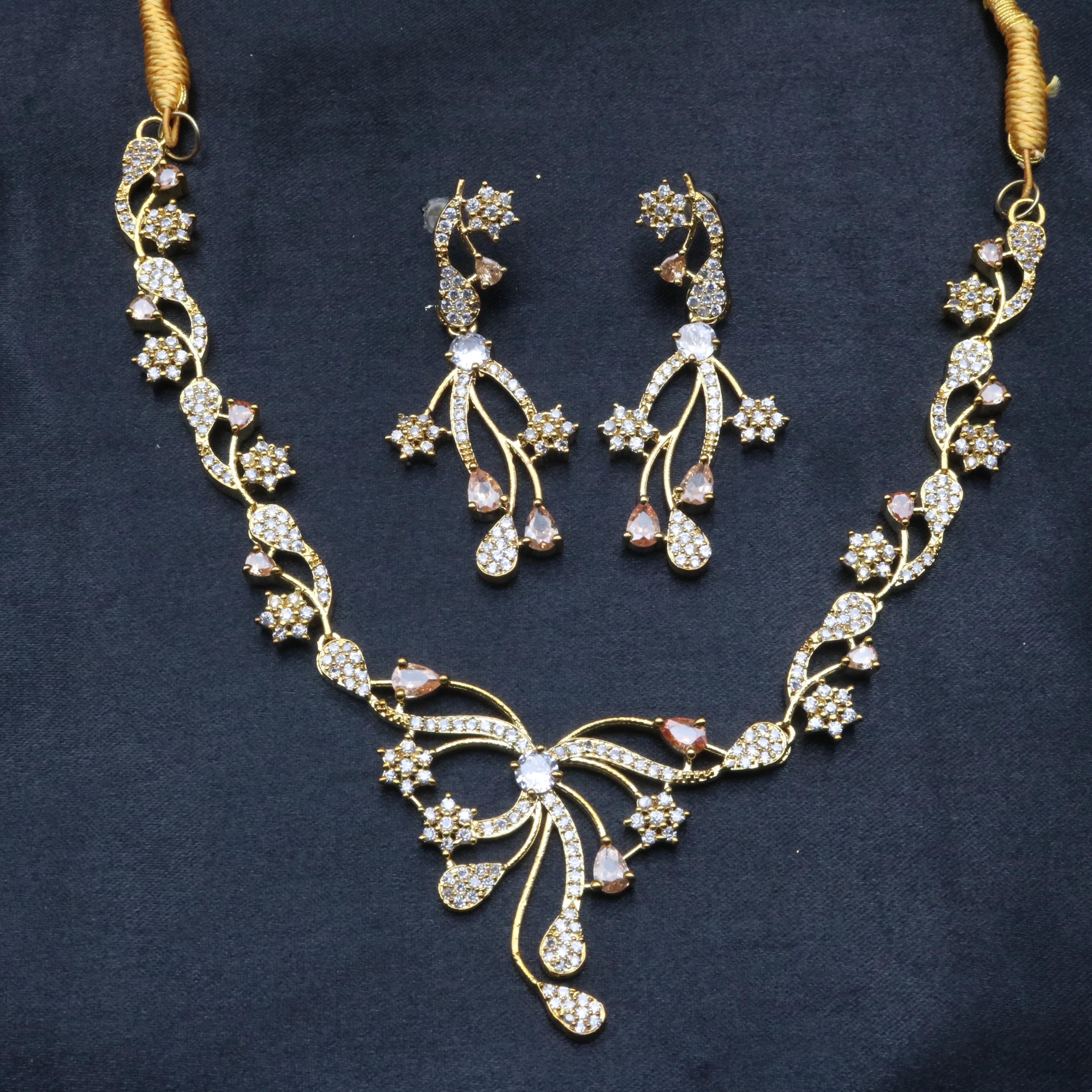 Opera necklace and earrings set featuring delicate floral patterns and curved vine-like elements
