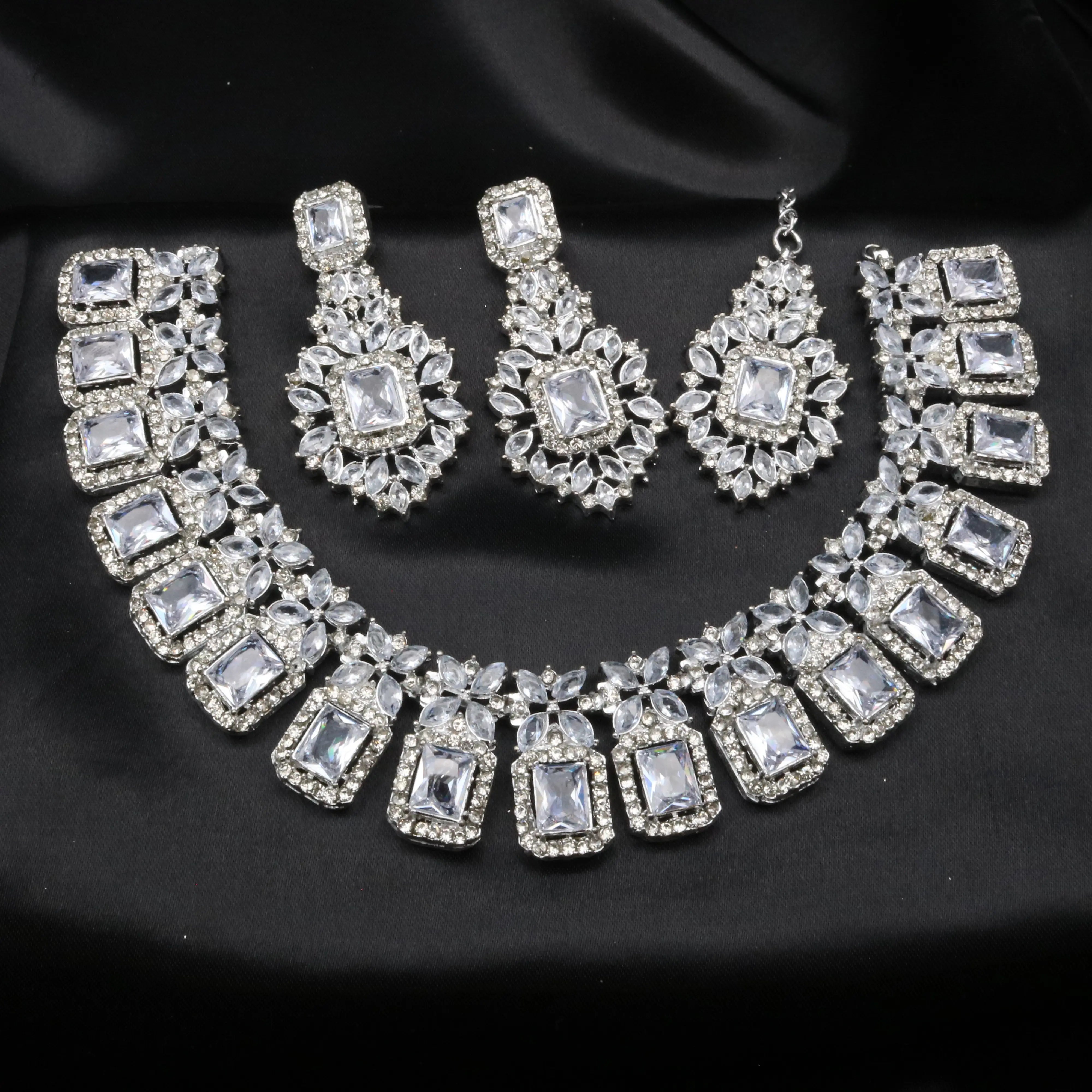 Pascal silver necklace set with matching earrings and teeka laid on black satin