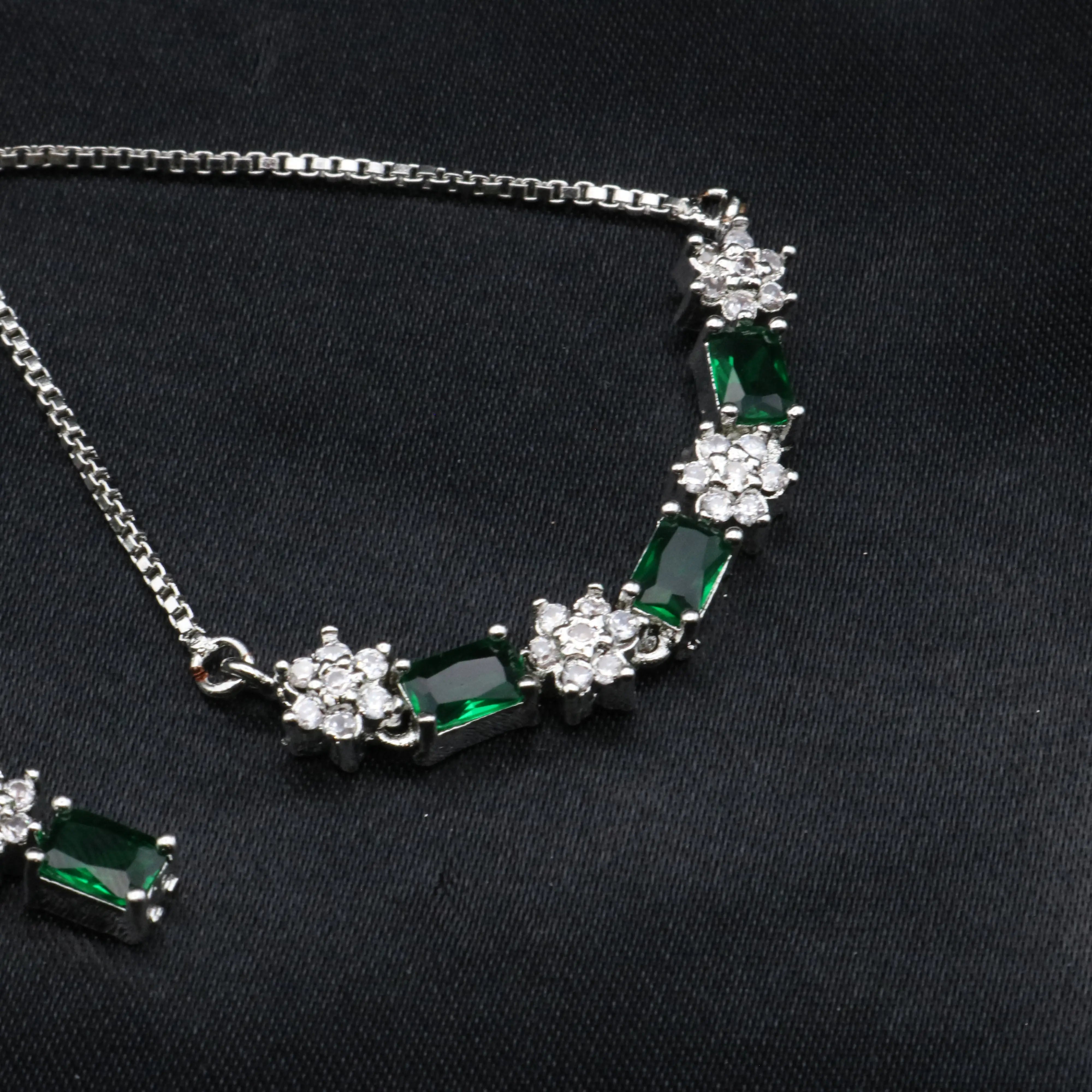 Emerald green adjustable bracelet from Reverie set with alternating CZ and gemstone links