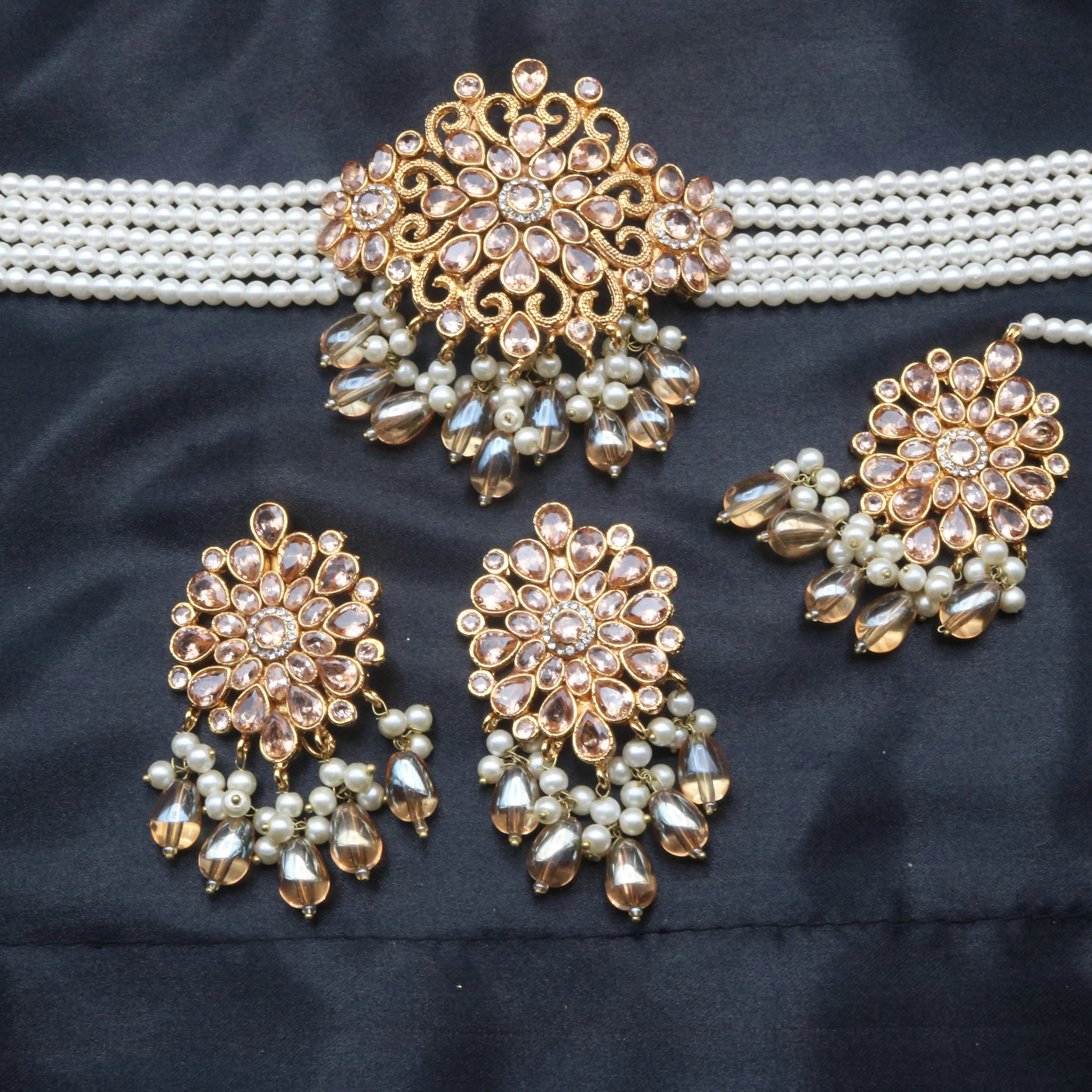 Close-up of Serenity necklace centerpiece with champagne CZ stones, pearls, and hanging beads