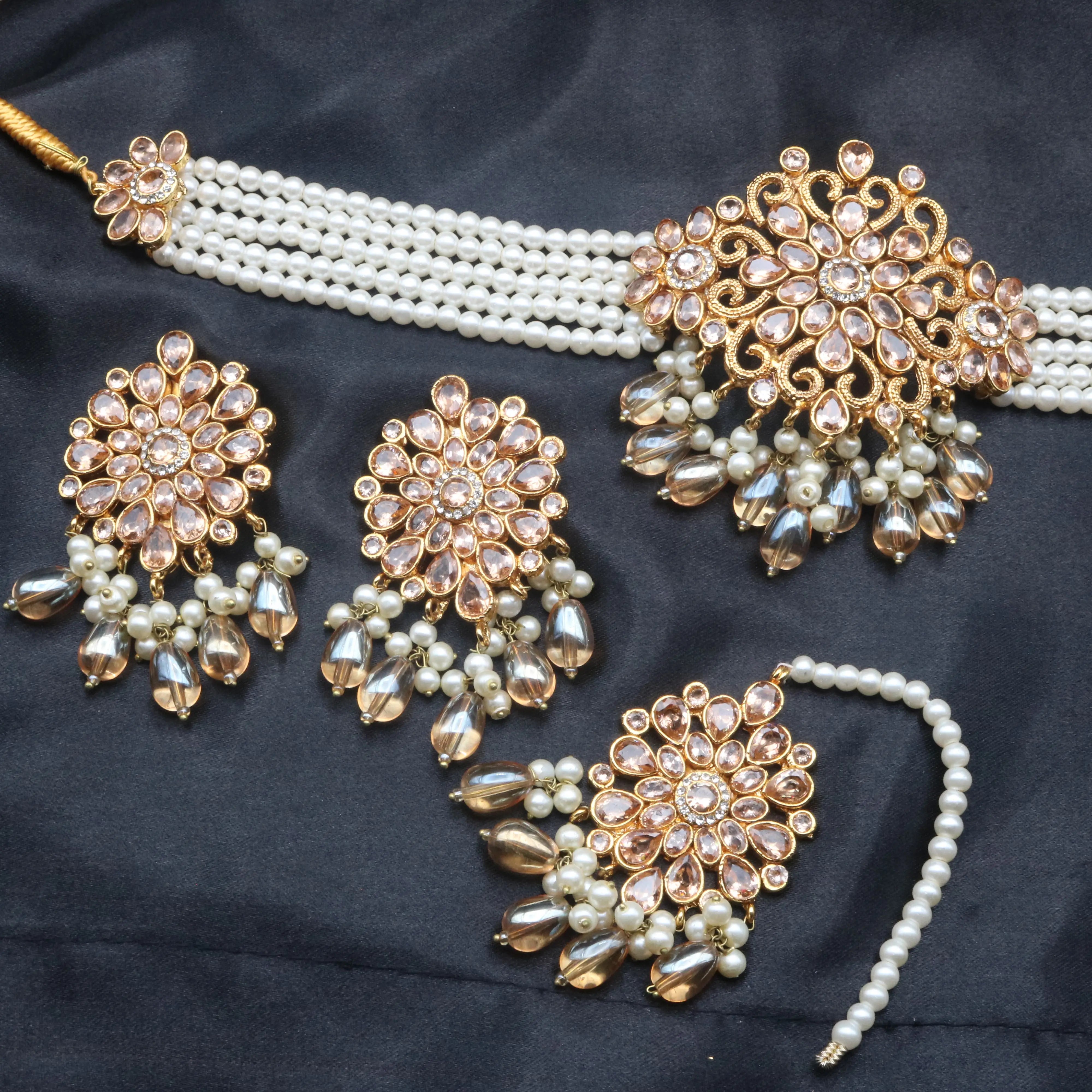Complete Serenity jewelry set with pearl choker, earrings, and matching tikka laid flat for display