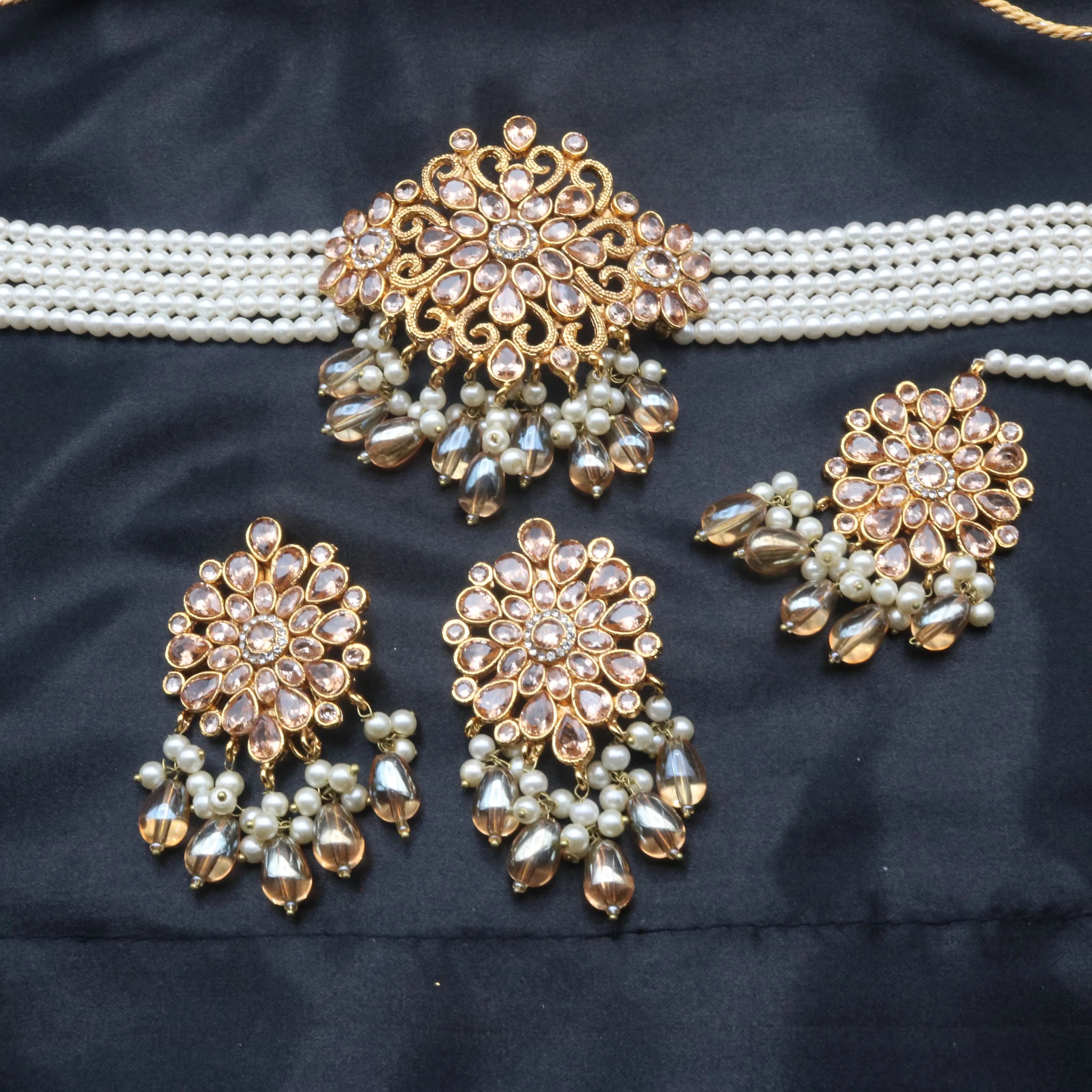 Serenity necklace set including choker and earrings with floral CZ motif on dark fabric background