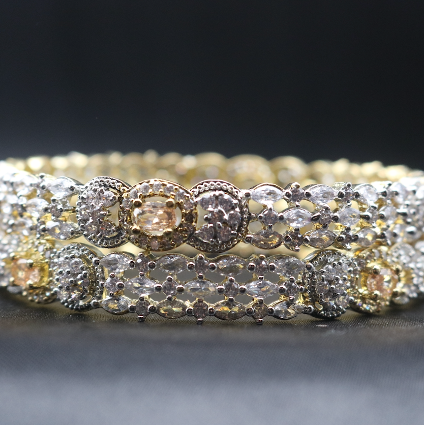 A set of gold-plated stainless steel bangles adorned with American diamond accents.