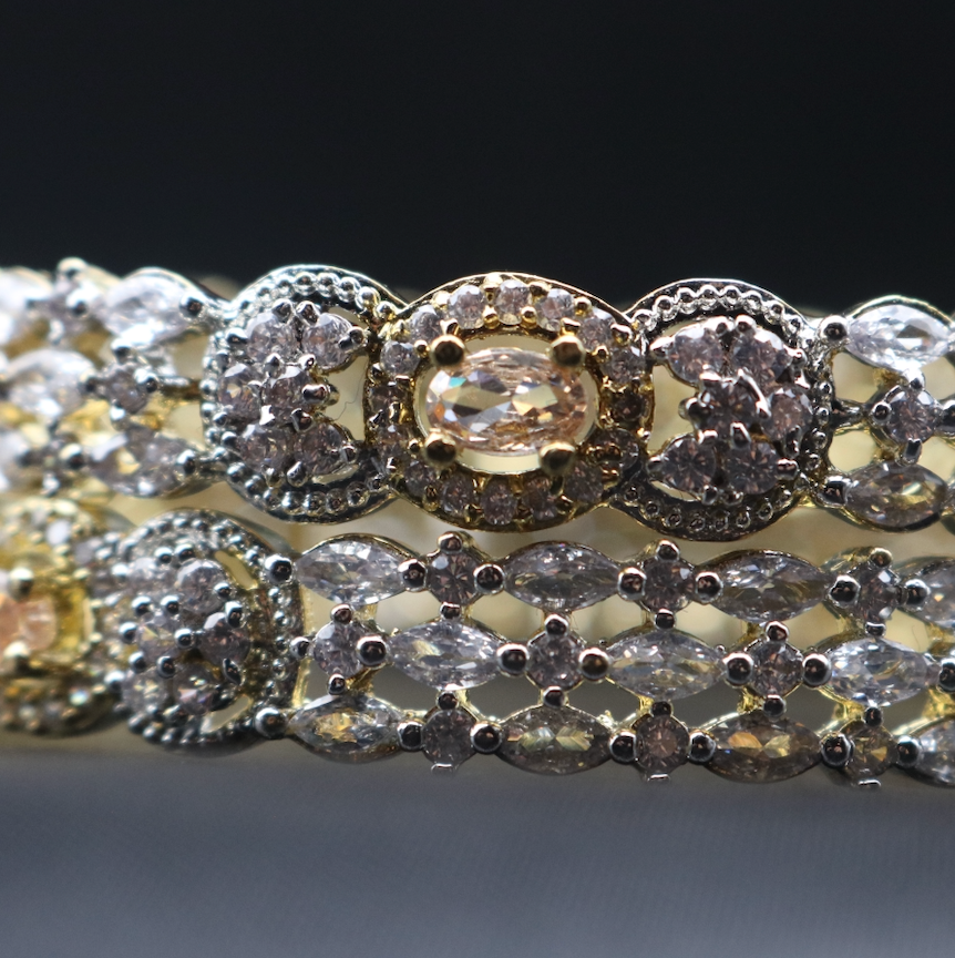 A closer view of set of gold-plated stainless steel bangles adorned with American diamond accents.