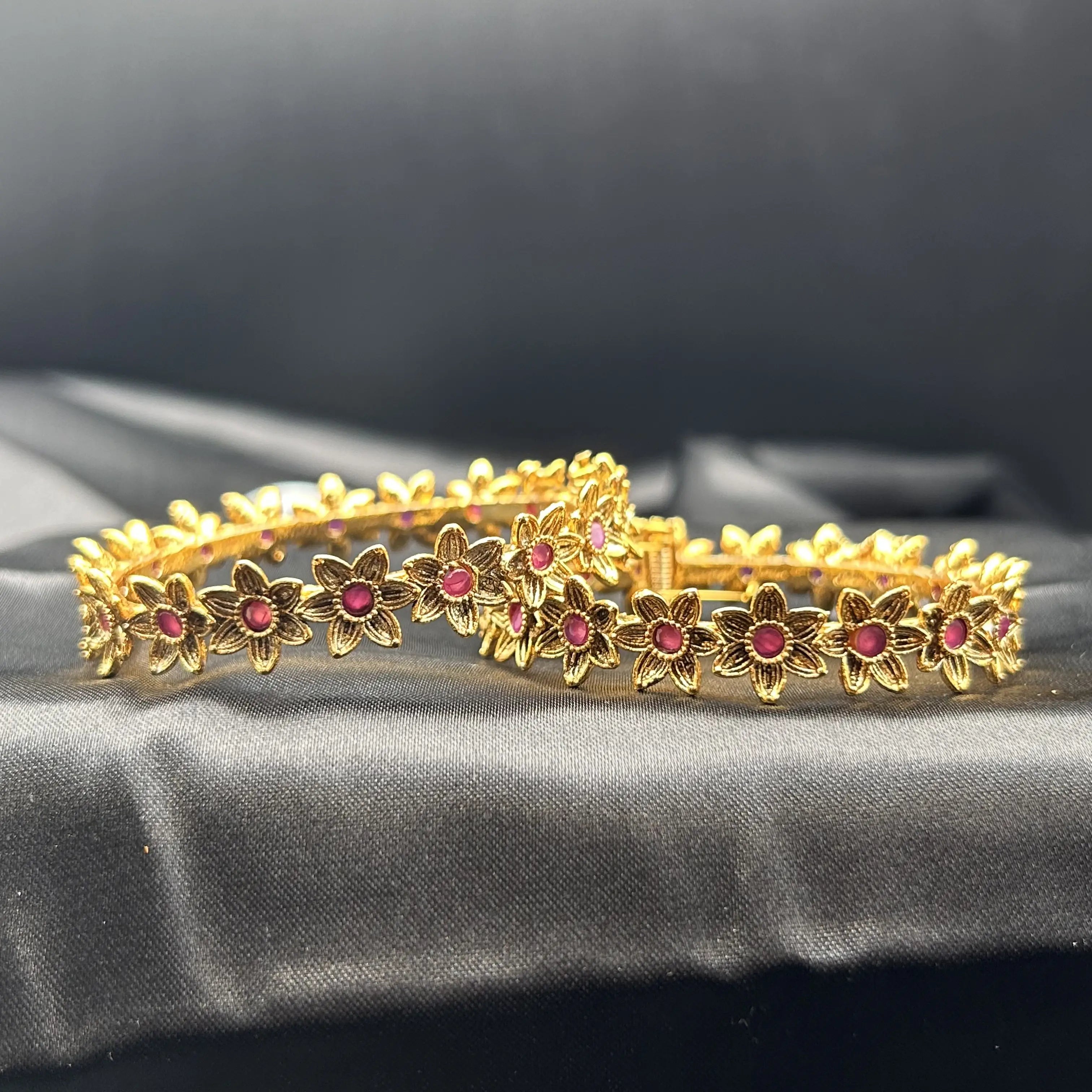 laying flat Pink-stone gold floral bangles with clasp design