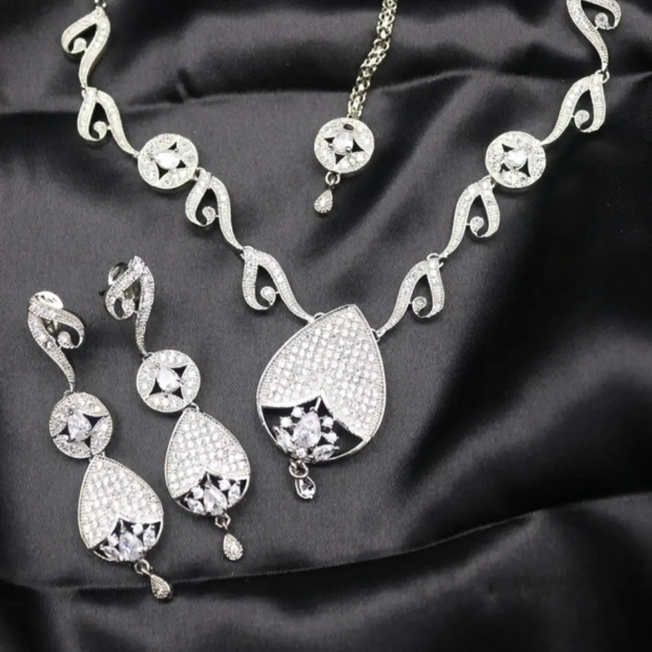 Strawberry Necklace Set displayed on black fabric with silver teardrop pendant and CZ earrings