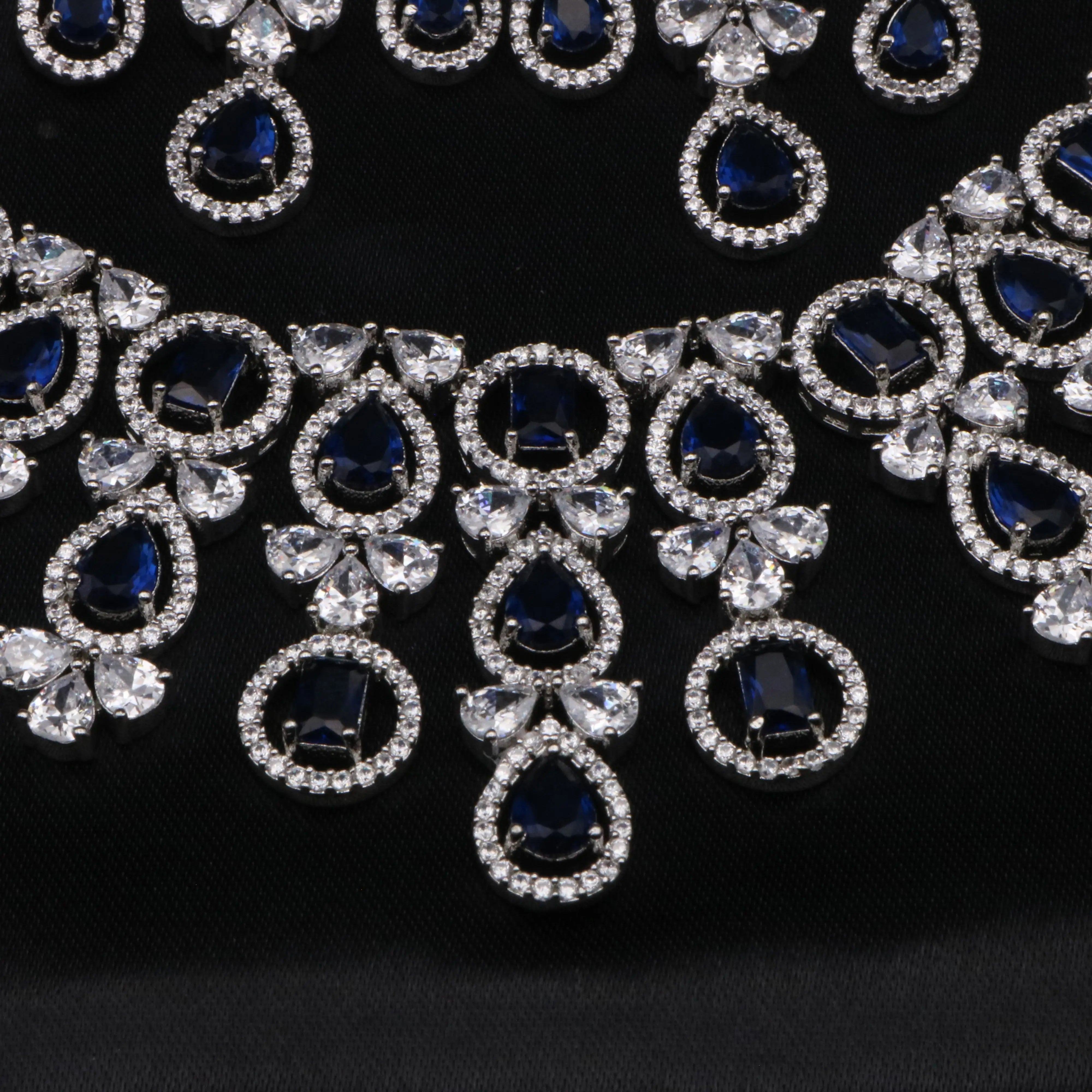 Detailed view of the Swanlake necklace centerpiece with royal blue stones and pear-cut white stones