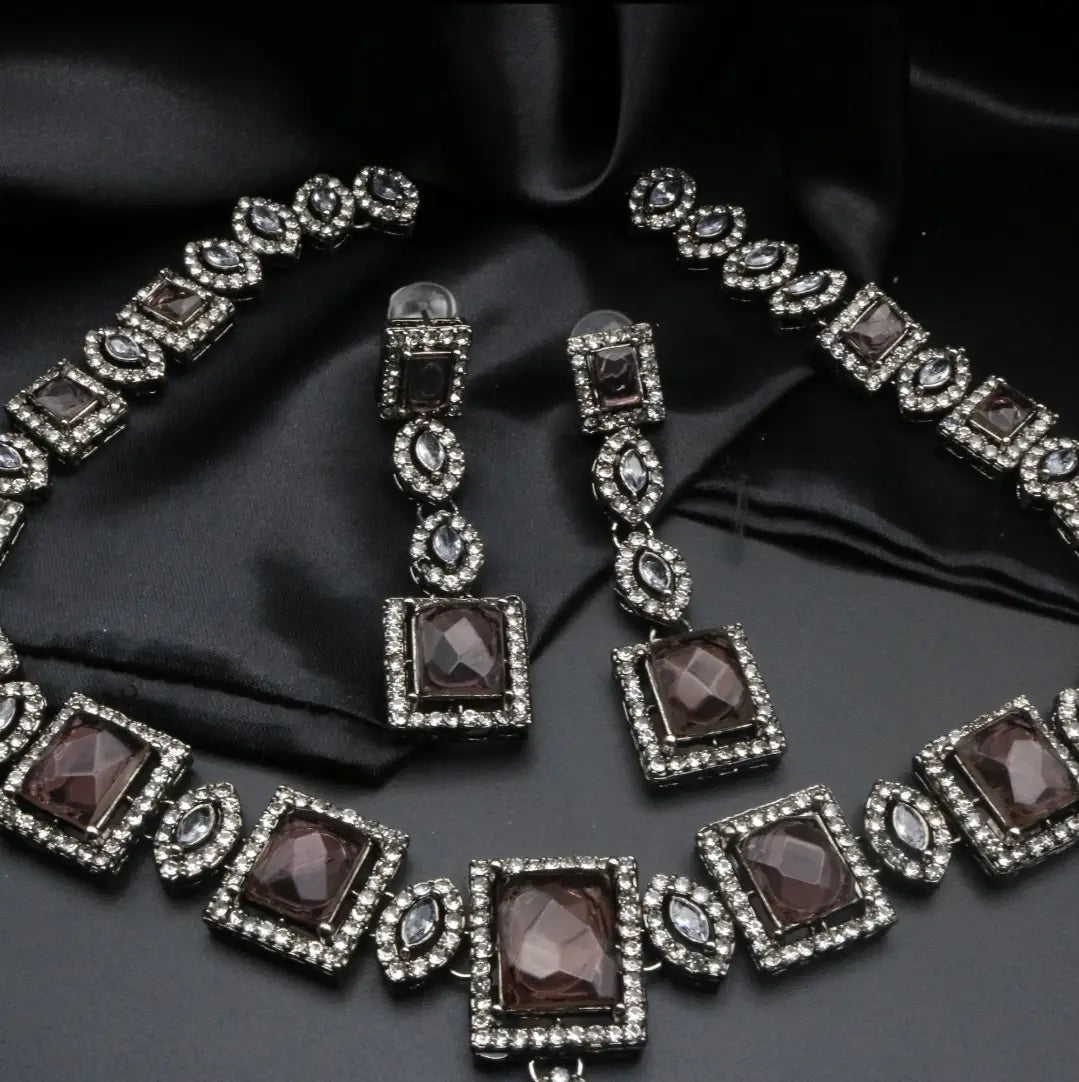 Complete Taj Mahal set in smoky stones and silver-toned plating on satin backdrop