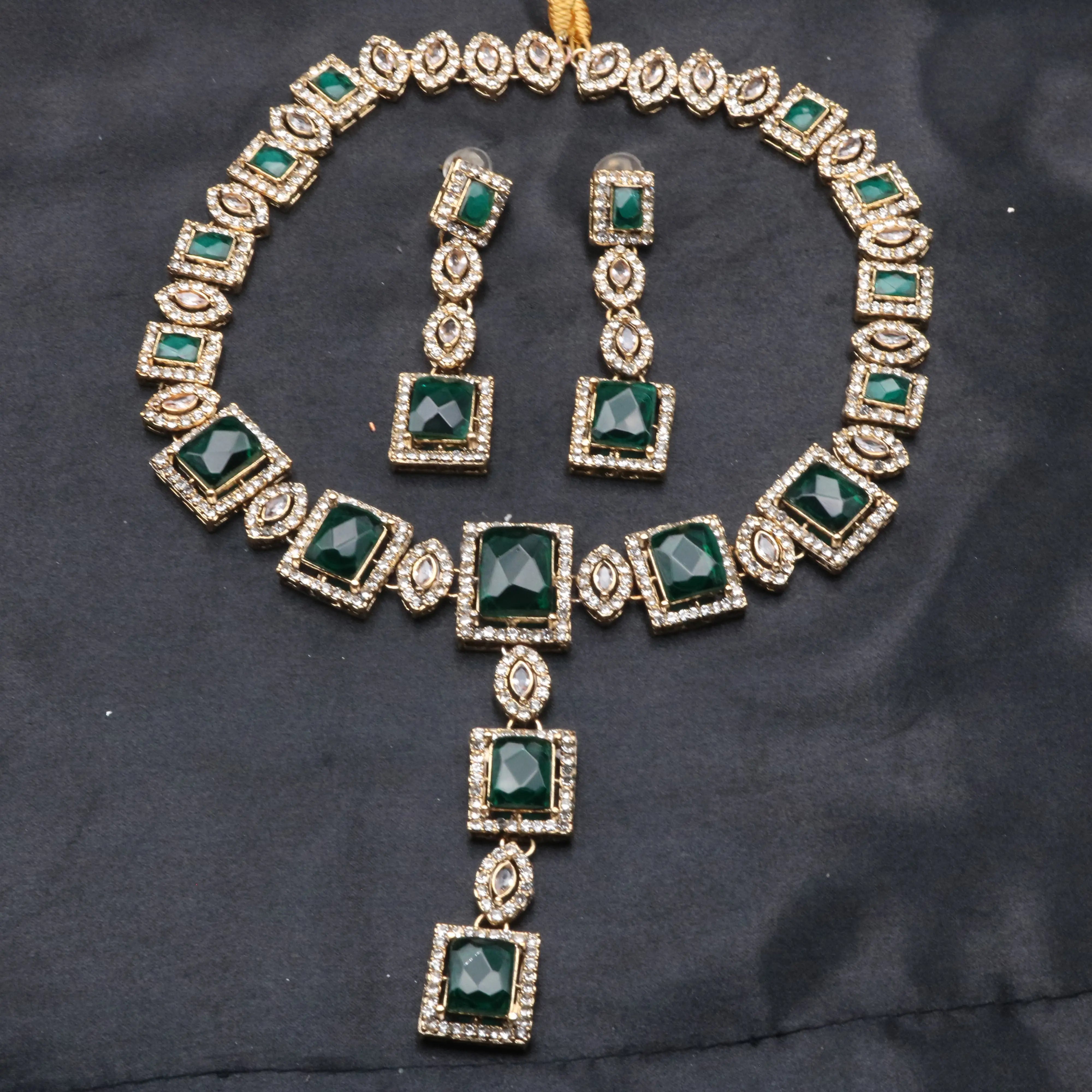 Full front-facing shot of emerald Taj Mahal set laid out with earrings