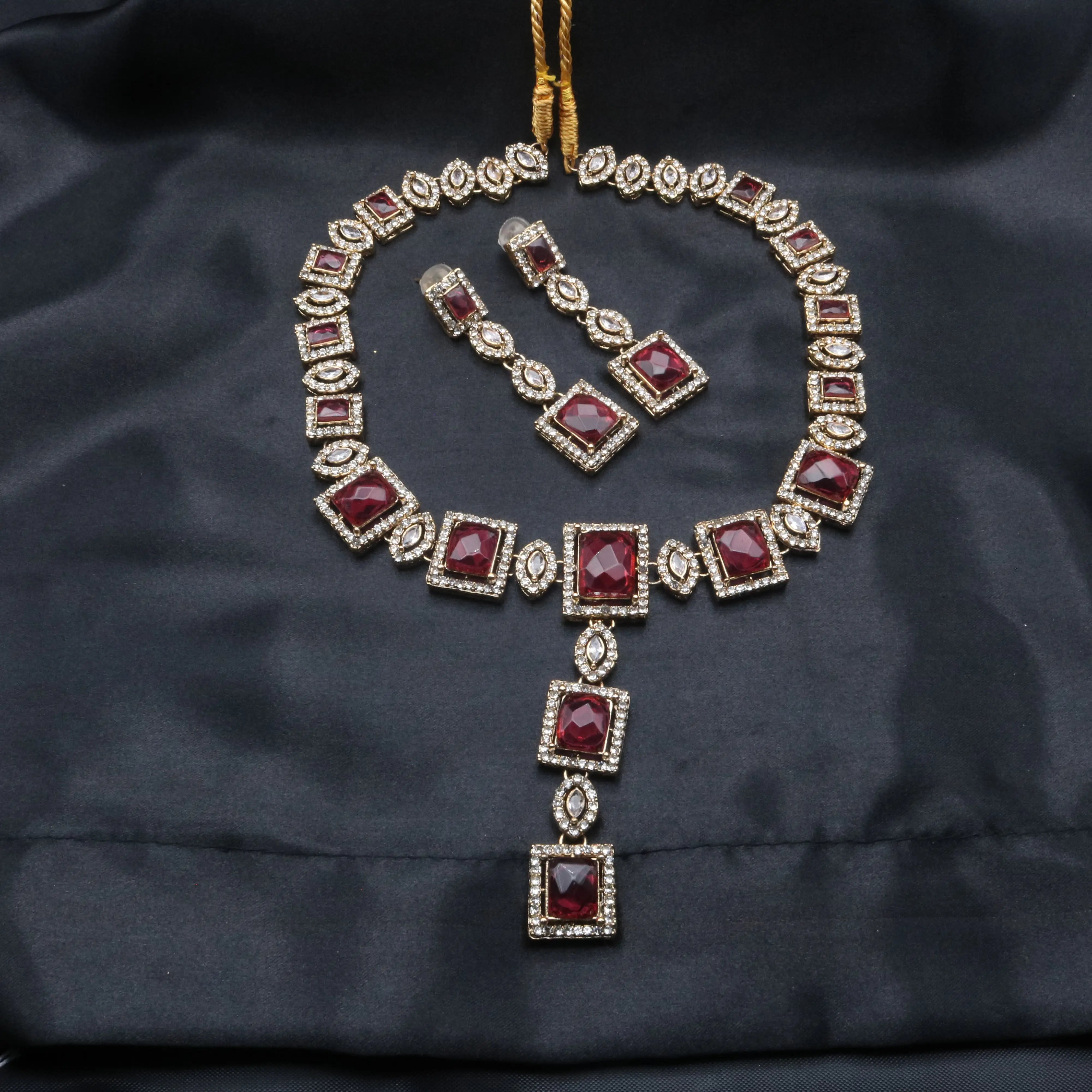 Full display of hotpink Taj Mahal set with earrings and pendant necklace on black background