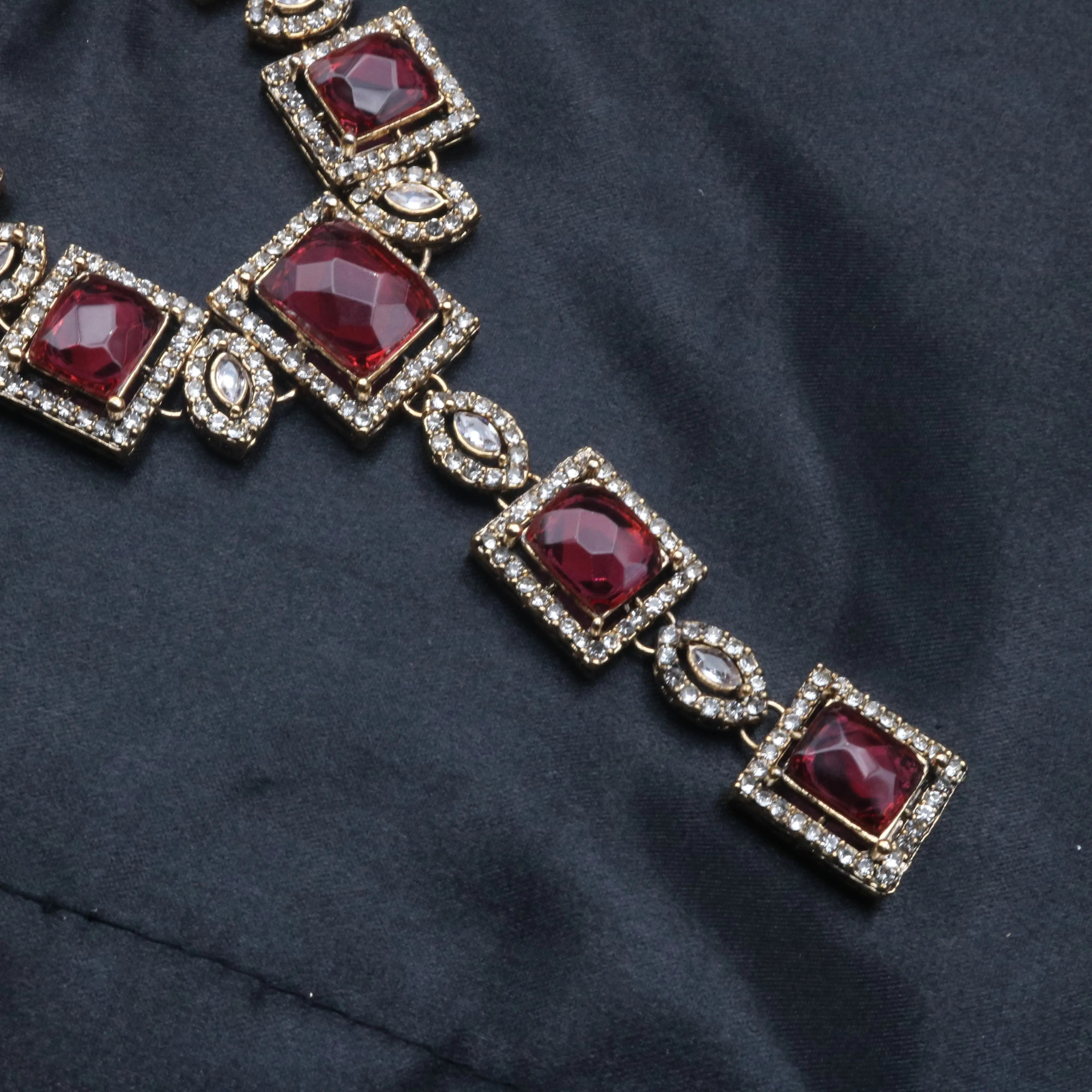 accent  close-up of Taj Mahal necklace set in hotpink with gold-plated finish and square CZ stones