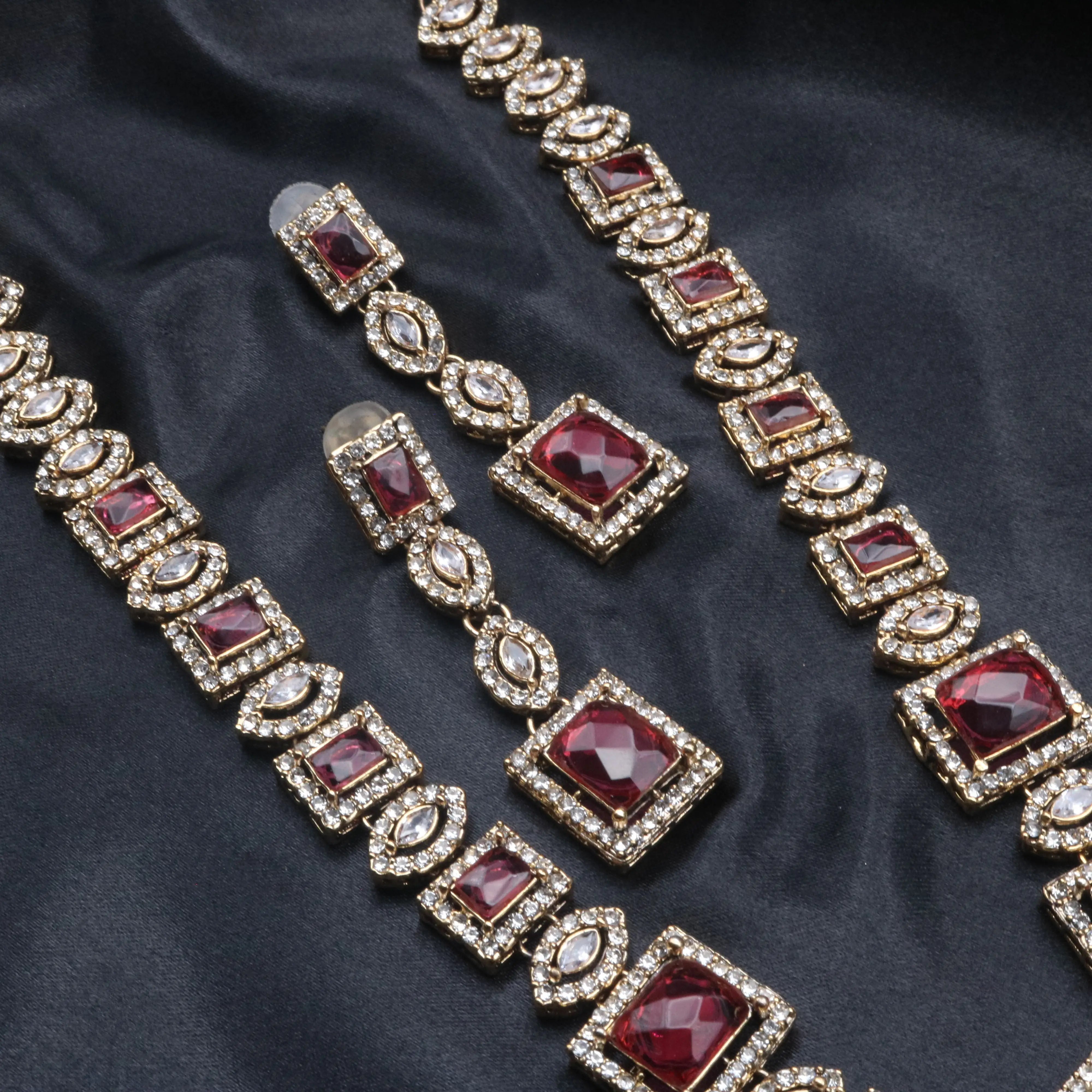 Close-up of Taj Mahal necklace set in hotpink with gold-plated finish and square CZ stones