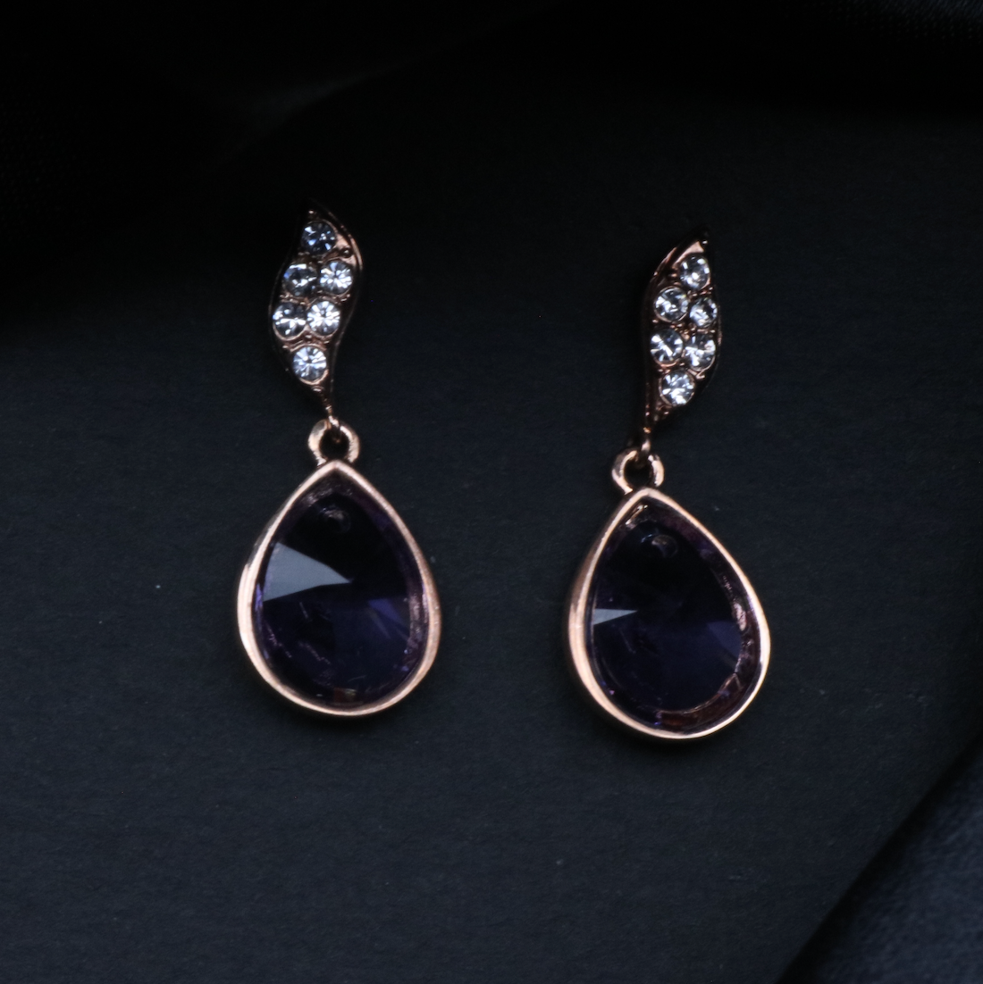 A pair of gold-plated stainless steel earrings with American diamonds set in a classic drop style.