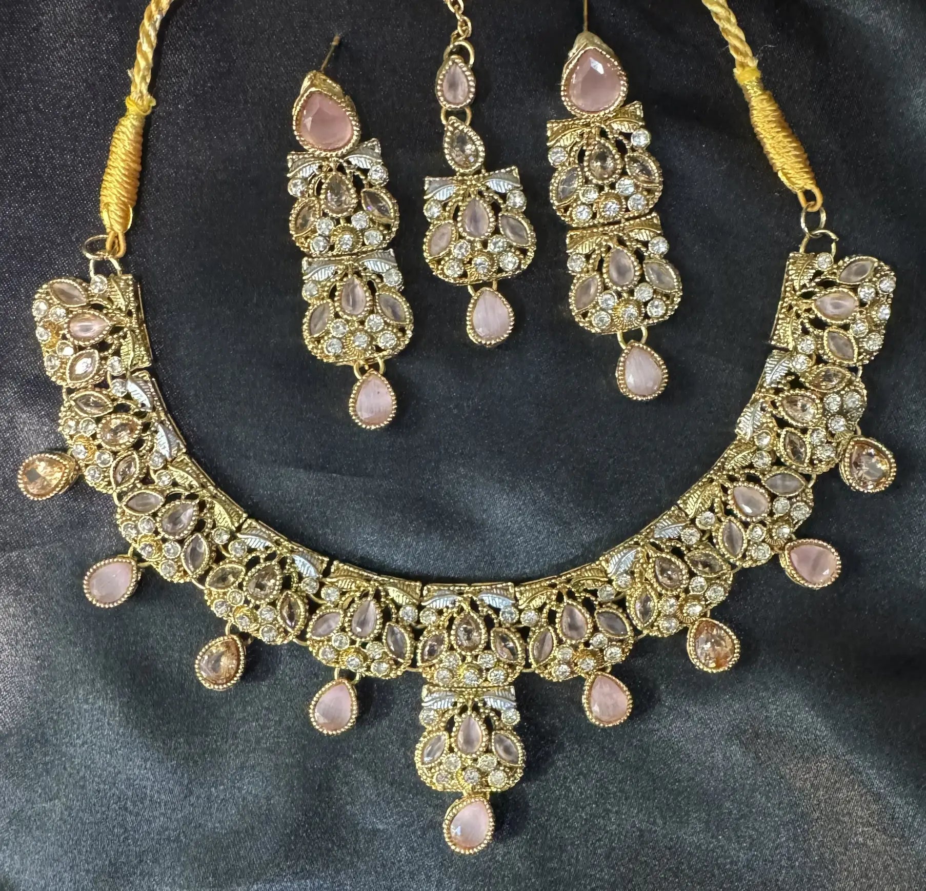 Zahra bridal necklace set in gold finish with pink pear-cut stones and CZ detailing, includes earrings and teeka